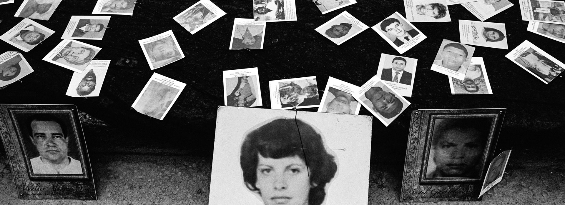 Photographs of victims of forced disappearance lie on the street in front of the Special Jurisdiction for Peace (JEP) building in the Colombian capital Bogotá, as part of a protest to demand that the court open a macro-case (one with a societal, rather than individual focus) into forced disappearances. The JEP was established in 2017 to investigate and try abuses committed during Colombia&rsquo;s internal conflict. The photo in the foreground is of the economist and sociologist Nydia Erika Bautista, who joined the 19th of April Movement (M-19), a leftist urban guerilla movement, which after its demobilization became a political party. Bautista was disappeared and murdered by members of the Colombian national army in 1987.