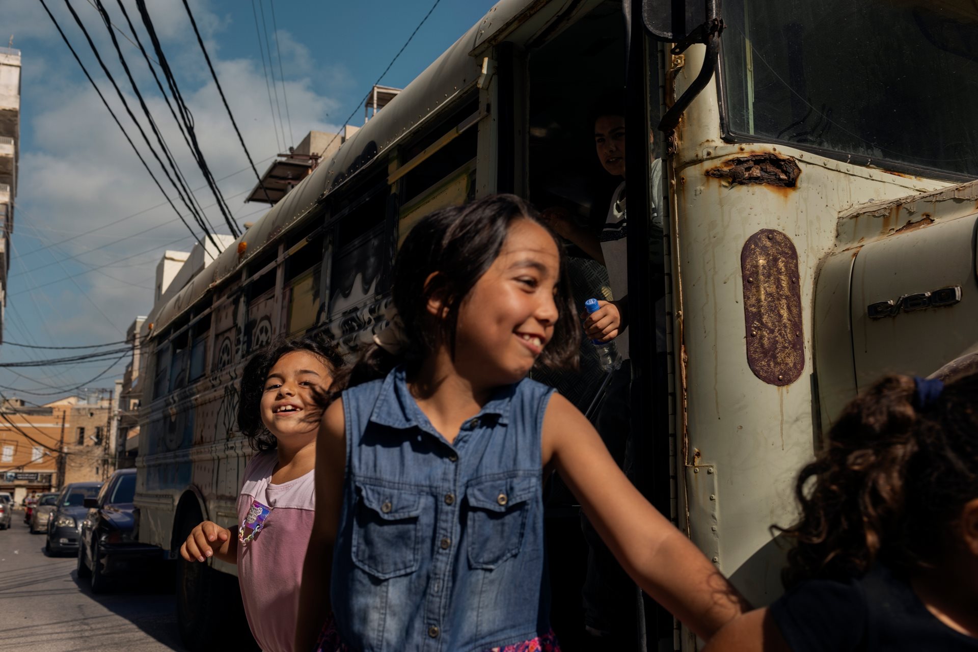 A displaced Lebanese child exits the Peace Art Bus outside the Lebanese National Theater in Tyre, Lebanon, to participate in artistic activities designed to alleviate stress.