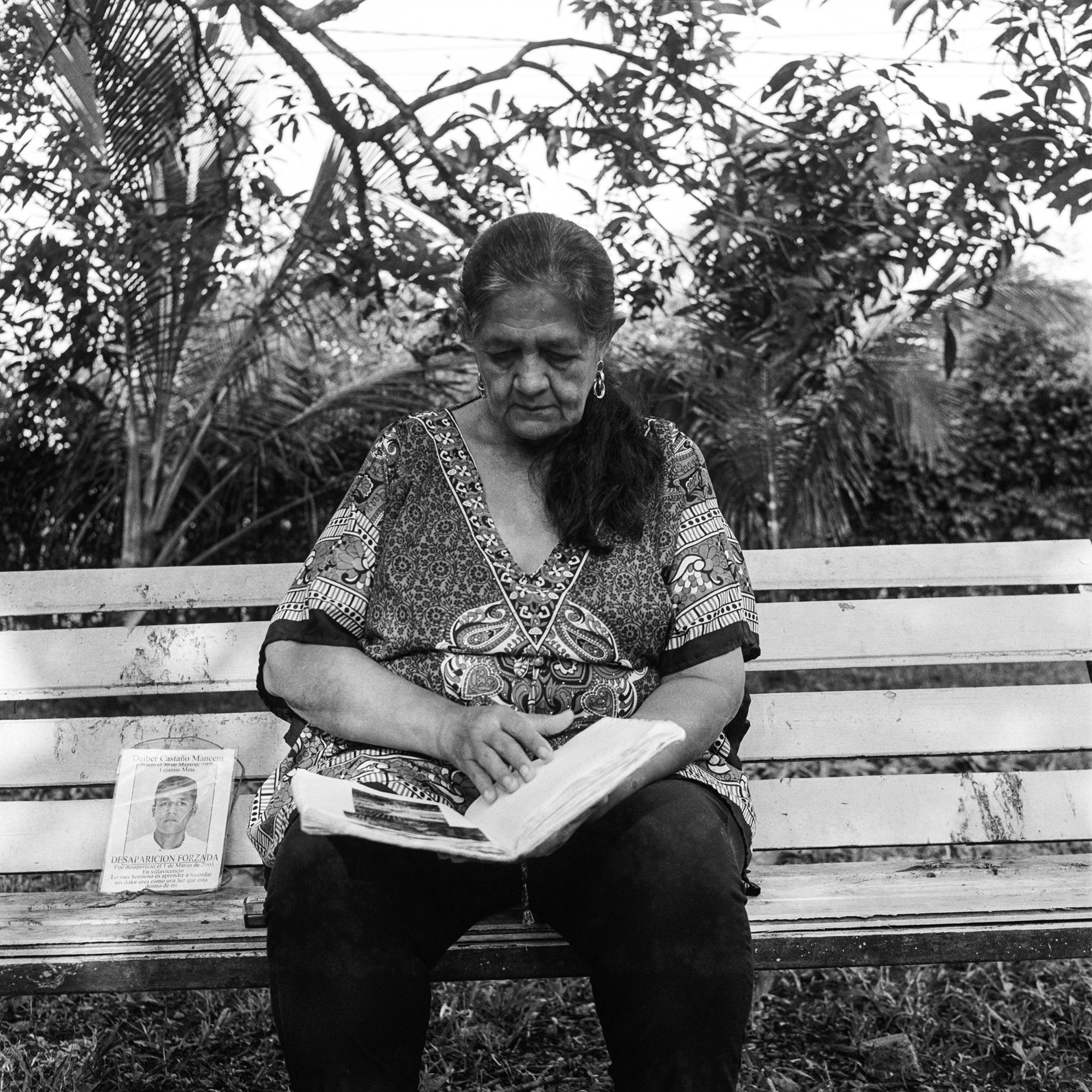 Nidia Mancera flips through her memory diary, the day before the 17th anniversary of her son Deiber Castaño Mancera&#39;s disappearance. Deiber disappeared in March 2003, when he was 24. Nidia says she hopes that her son is alive and that someday he will return home.