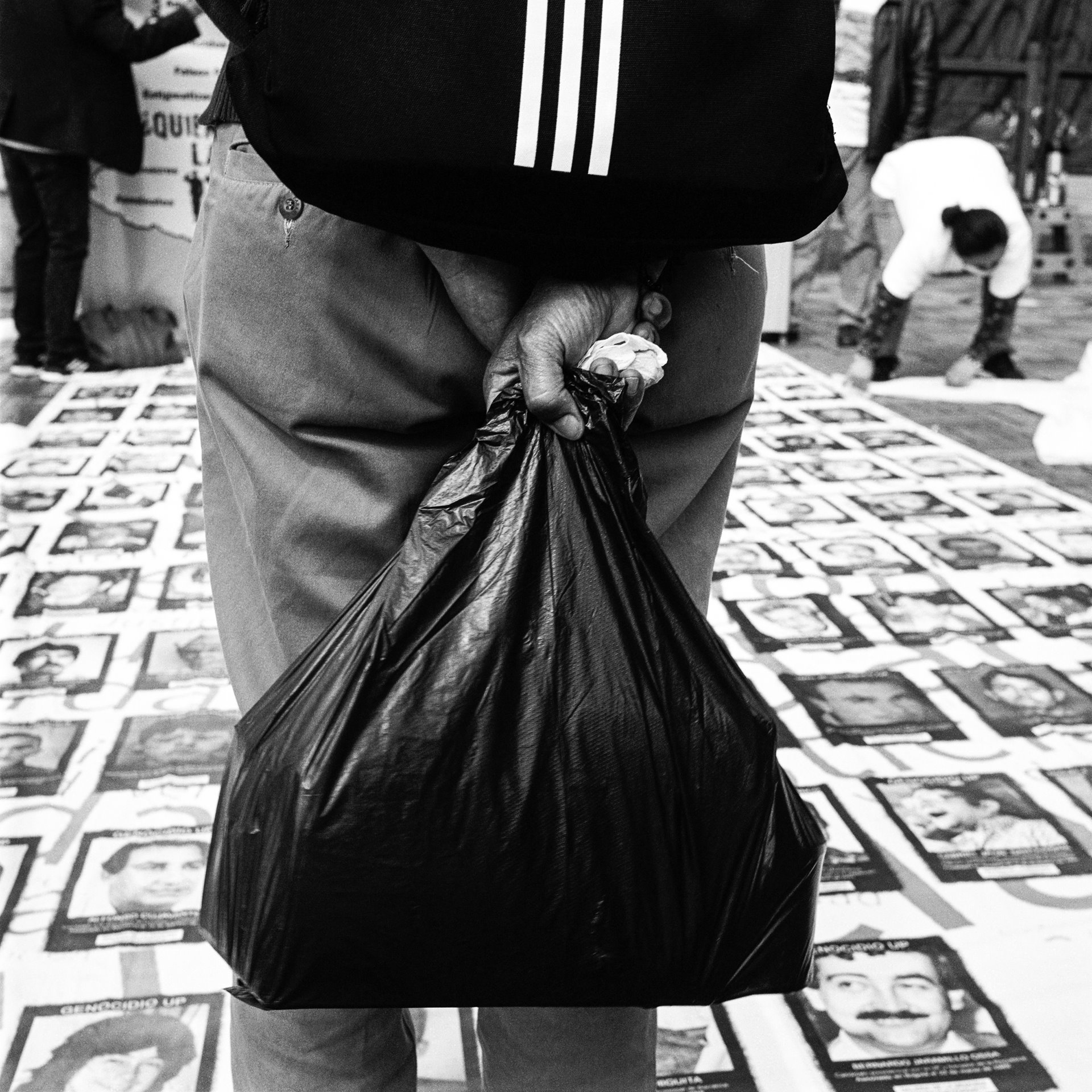 A passer-by looks at the photographs of missing persons, during a protest organized by the National Movement of Victims of State Crimes (MOVICE), on the 35th anniversary of the siege of the Palace of Justice in Bogotá, Colombia. In November 1985, members of the leftist M-19 guerrilla group took over the Palace of Justice in Bogotá, taking hundreds of people hostage, including all 25 of the Supreme Court justices. The Colombian army stormed and retook the palace, in an operation that left up to 100 people dead, including many justices. Eleven survivors were taken away by the military and never seen again.
