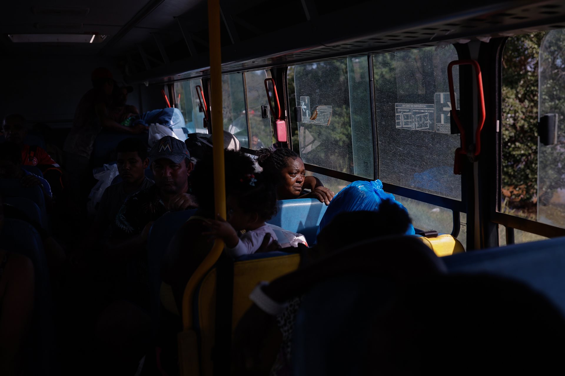 Cintia Santos and her family are evacuated by bus from a flooded area. Rising sea levels, aridity, floods and other disasters caused by climate change are expected to make certain areas unlivable by 2050. Eldorado do Sul, Rio Grande do Sul, Brazil.
