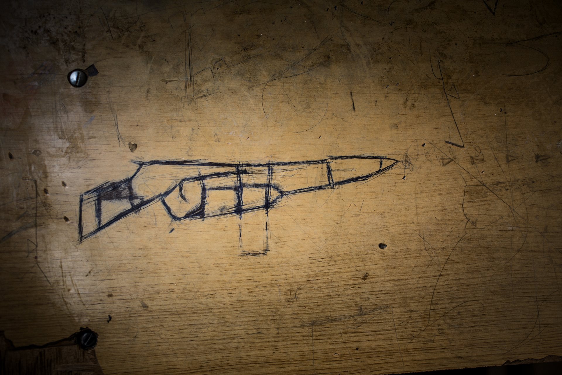 A drawing of a machine gun on a desk at Hajj Ali High School for boys, taken over as a shelter during conflict. Hajj Ali, Iraq.