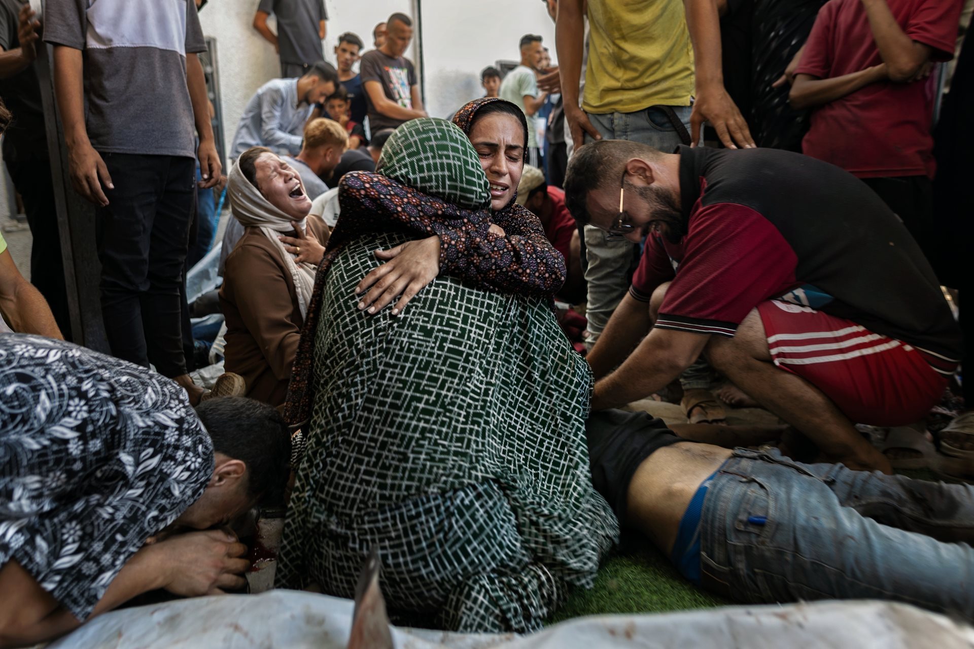 People mourn at a hospital after the Israeli military attacked a beachfront cafe west of Gaza City, Gaza Strip. More than 30 people were killed, including a Hamas operative and a journalist. Dozens were wounded.