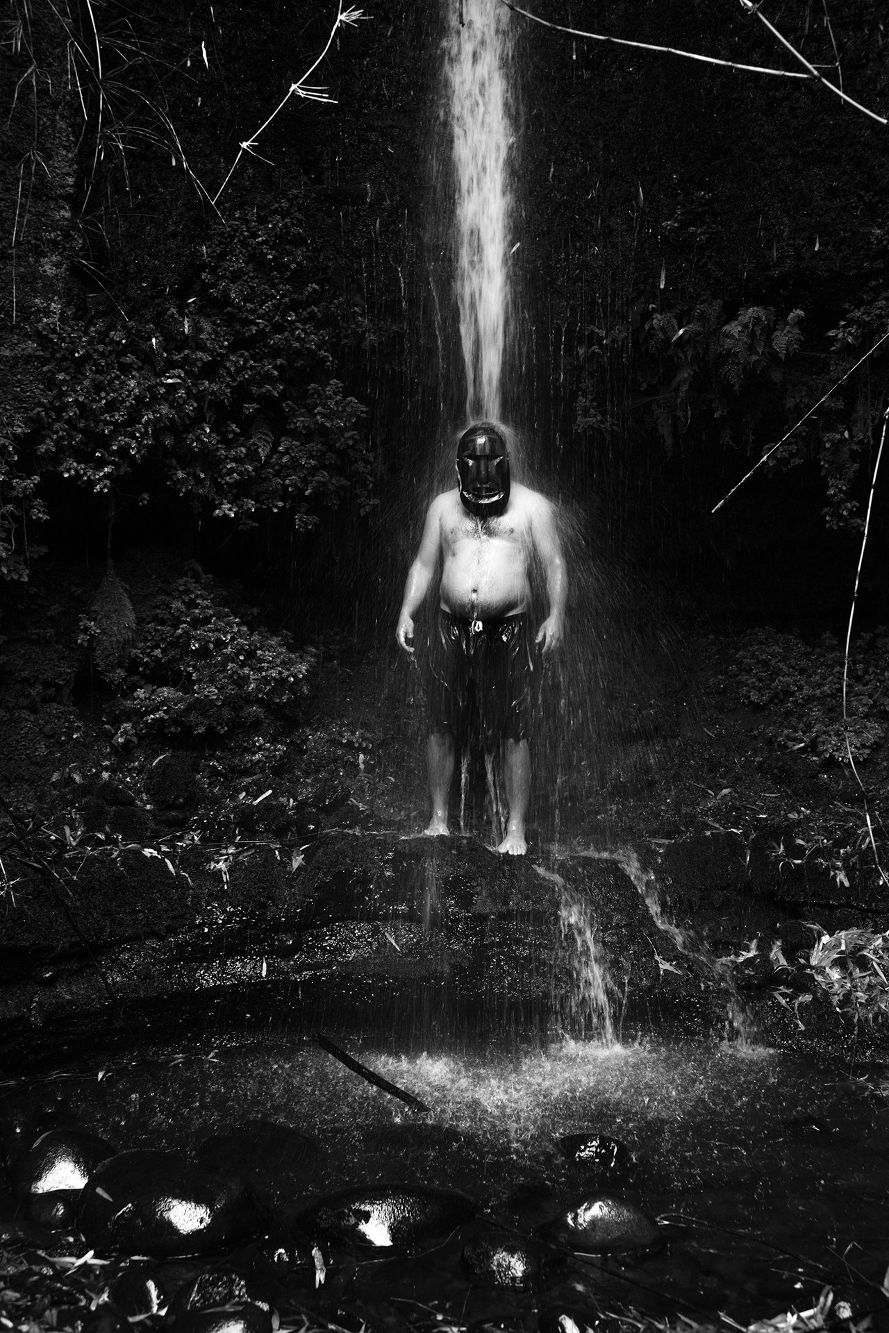 A man poses with a mask used in sacred Mapuche ceremonies under a waterfall, in Río Bueno, Los Rios, Chile. More than 150 Mapuche communities from the region were resisting the Norwegian state-owned company Statkraft&#39;s project to build two new hydroelectric plants, which they said threatened the ecological and spiritual balance of their ancestral territory.