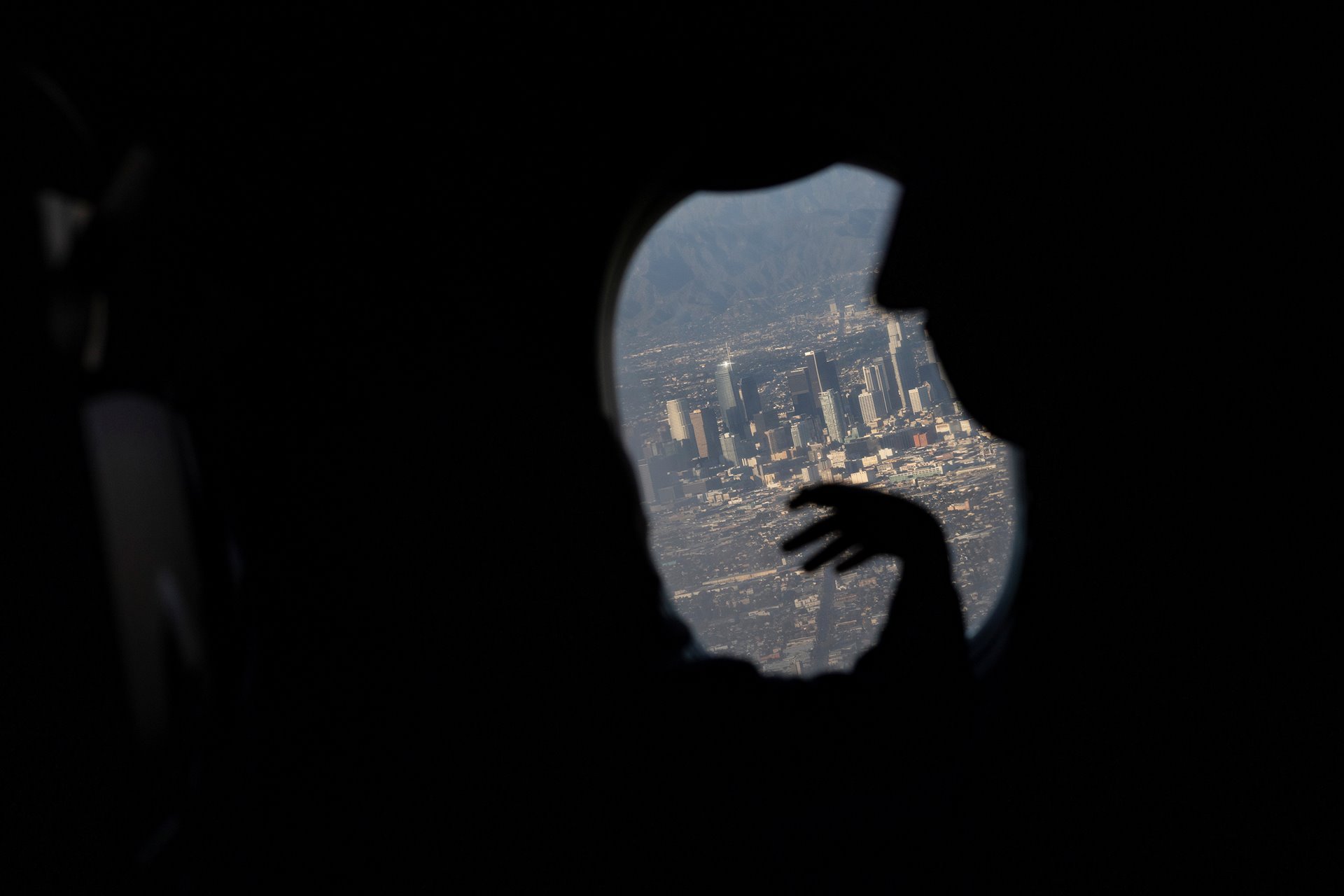 <p>Maria Hernandez and her grandson Aron look out at the city of Los Angeles, United States, from an airplane window as they arrive to reunite with their family. Maria had raised Aron since his mother relocated to the US years earlier in search of opportunities.</p>
