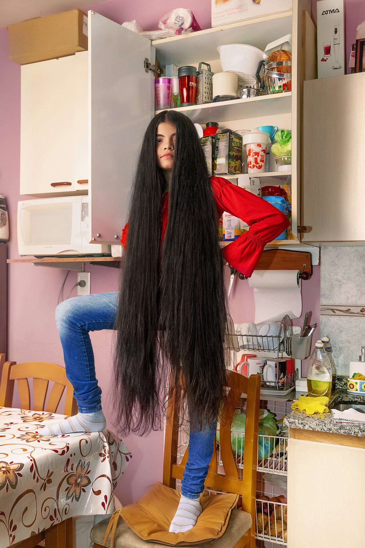 Antonella poses for her photograph in the kitchen at home, while in strict lockdown in Buenos Aires, Argentina, on the day she made her promise not to cut her hair till she could resume person-to-person classes.