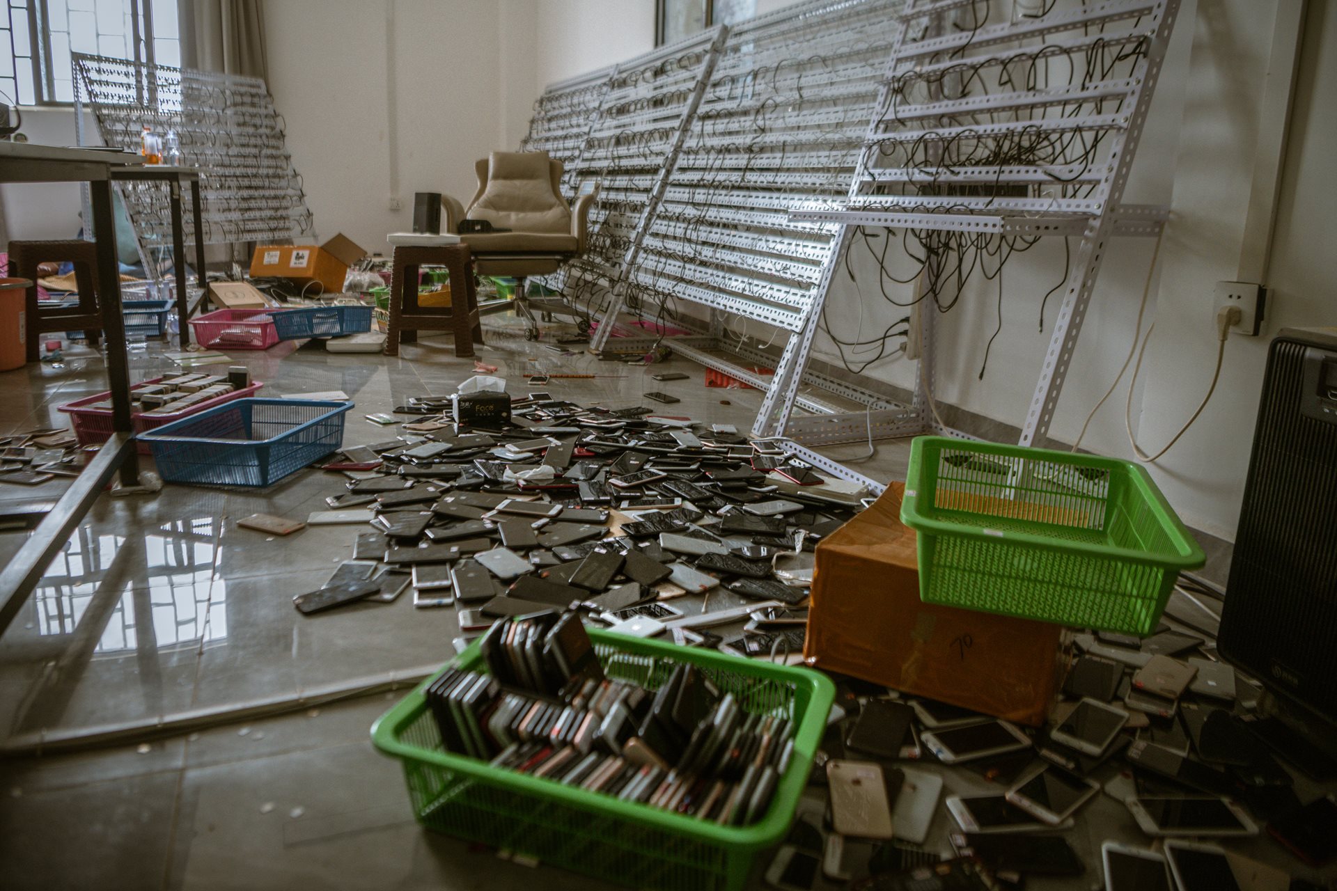 Discarded cellphones litter the Shunda Park in Min Let Pan, Myanmar complex after its capture. The scammers used generative intelligence, deepfake videos, fraudulent businesses, websites, and financial apps to reel in victims from around the world.