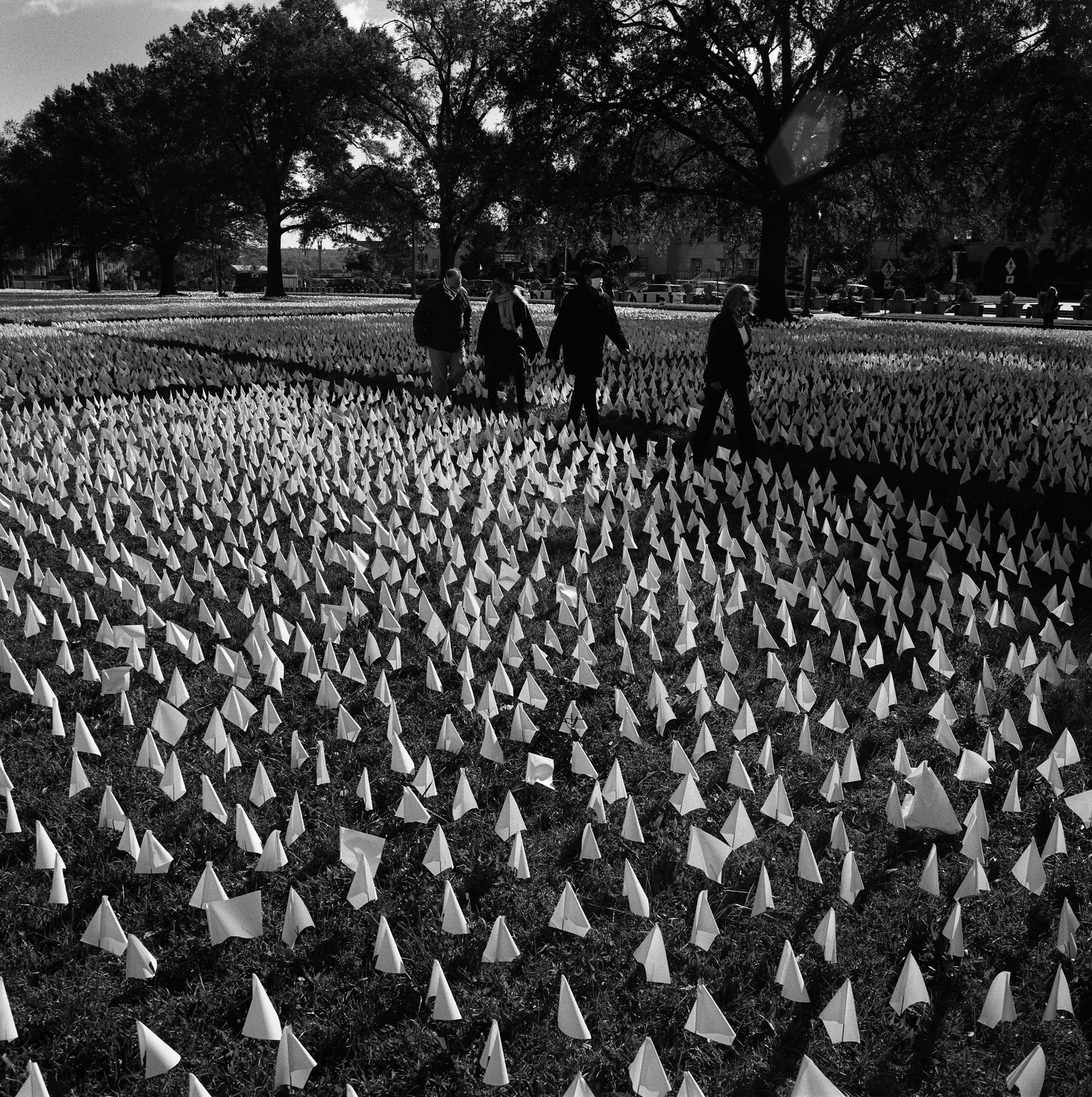 Speaker of the House of Representatives Nancy Pelosi, Mayor Muriel Bowser of the District of Columbia, artist Suzanne Brennan Firstenberg, and chef José Andrés walk past white flags representing more than 267,000 COVID-19 deaths, in an installation titled &lsquo;In America: How Could This Happen &hellip;&rsquo;, &nbsp;at the Robert F. Kennedy Memorial Stadium in Washington DC, USA.