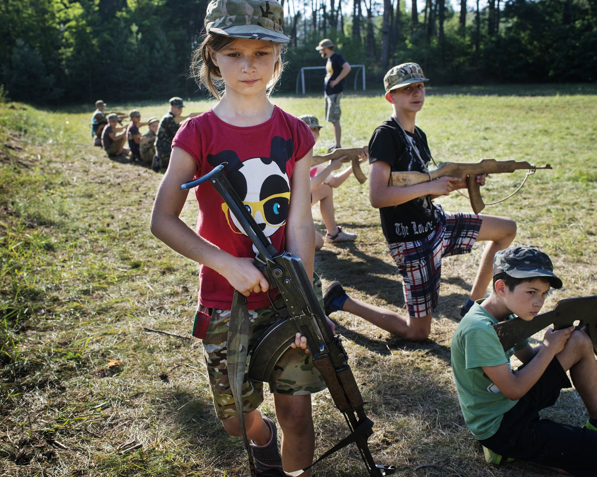 Children undergo military training at a summer camp for children aged from 7 to 18, in suburban Kyiv, Ukraine. The camp is one of a number organized by the Azov Battalion, a radical nationalist militia, now part of the National Guard, that leads the fight against pro-Russian separatists in eastern Ukraine.