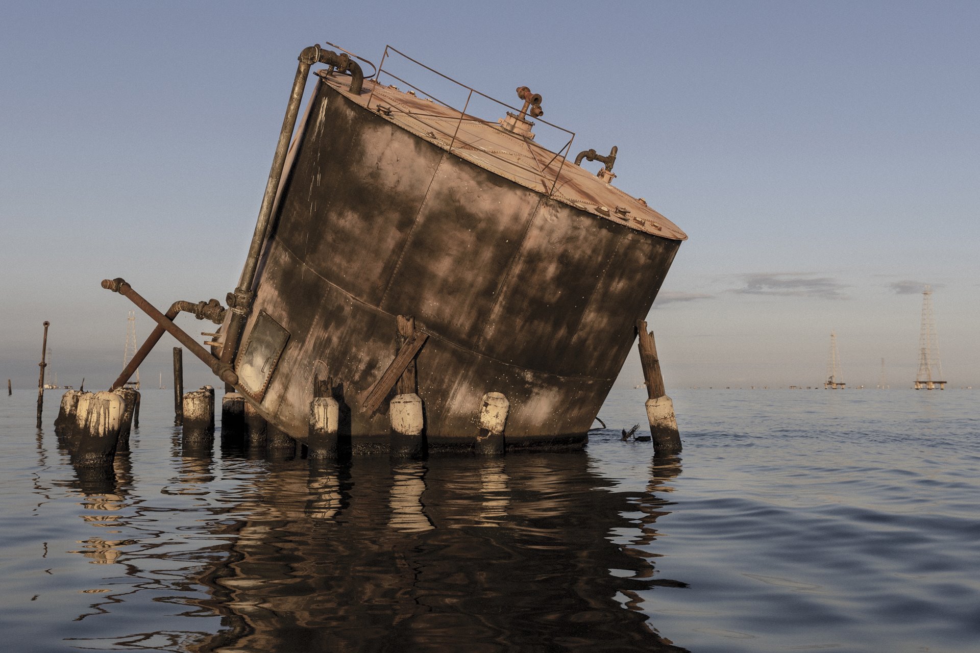 <p>An oil tank lies neglected in Lake Maracaibo, Zulia State, Venezuela. Poor maintenance, combined with lack of investment and human resources, have brought Venezuela&#39;s oil production to an historic low. In 1998, Venezuela produced an average of 3.1 million barrels of crude oil per day (bpd), by 2021 that had shrunk to 553,000 bpd, according to data presented by OPEC analysts, though output began to rise again in 2022.</p>
