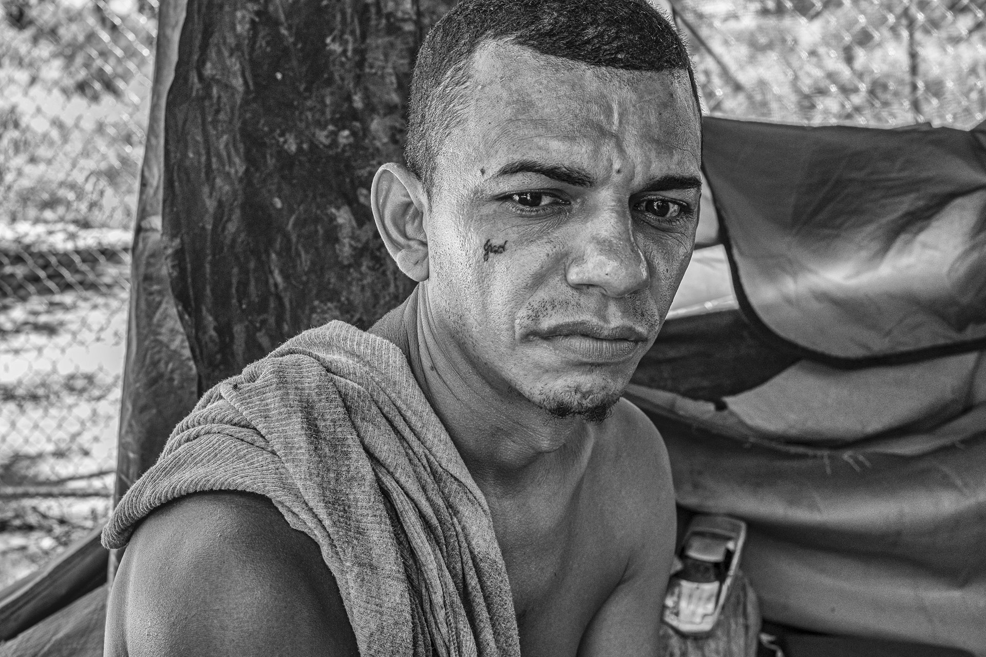 Milton Vado poses for a portrait at an asylum seeker&rsquo;s camp in Matamoros, Mexico. Milton lived in the camp from October 2019 to January 2021, when the camp was dismantled. His wife and two sons crossed into the United States before him, but he had to wait for his asylum hearing at the camp because he arrived from El Salvador.&nbsp;