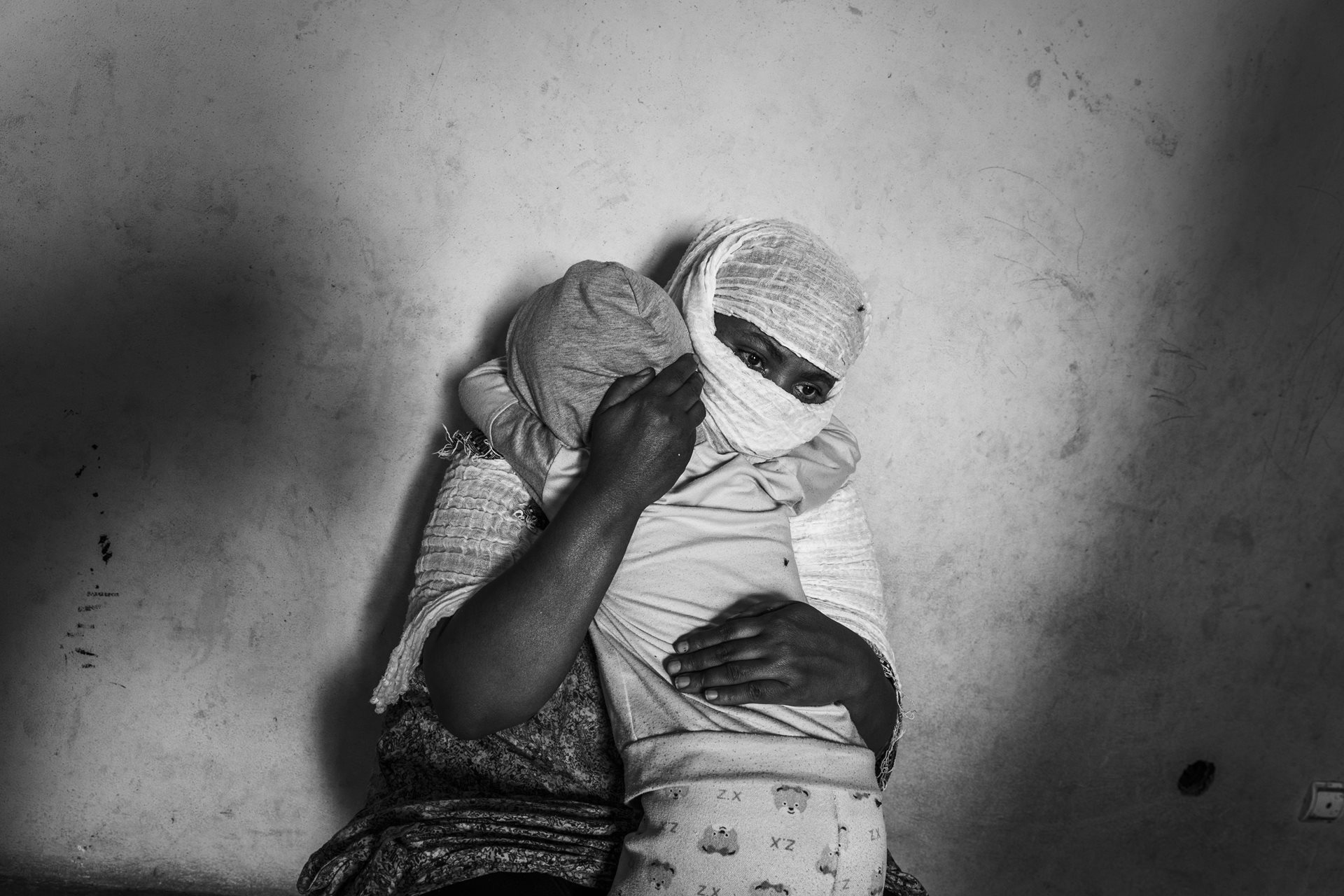 Tsigue (39, not her real name) and her daughter (5) embrace each other in Adigrat, Tigray, Ethiopia. Tsigue was raped by Eritrean soldiers when the war began. Her husband left her shortly thereafter. Women raped during the war are almost always abandoned by their husbands.