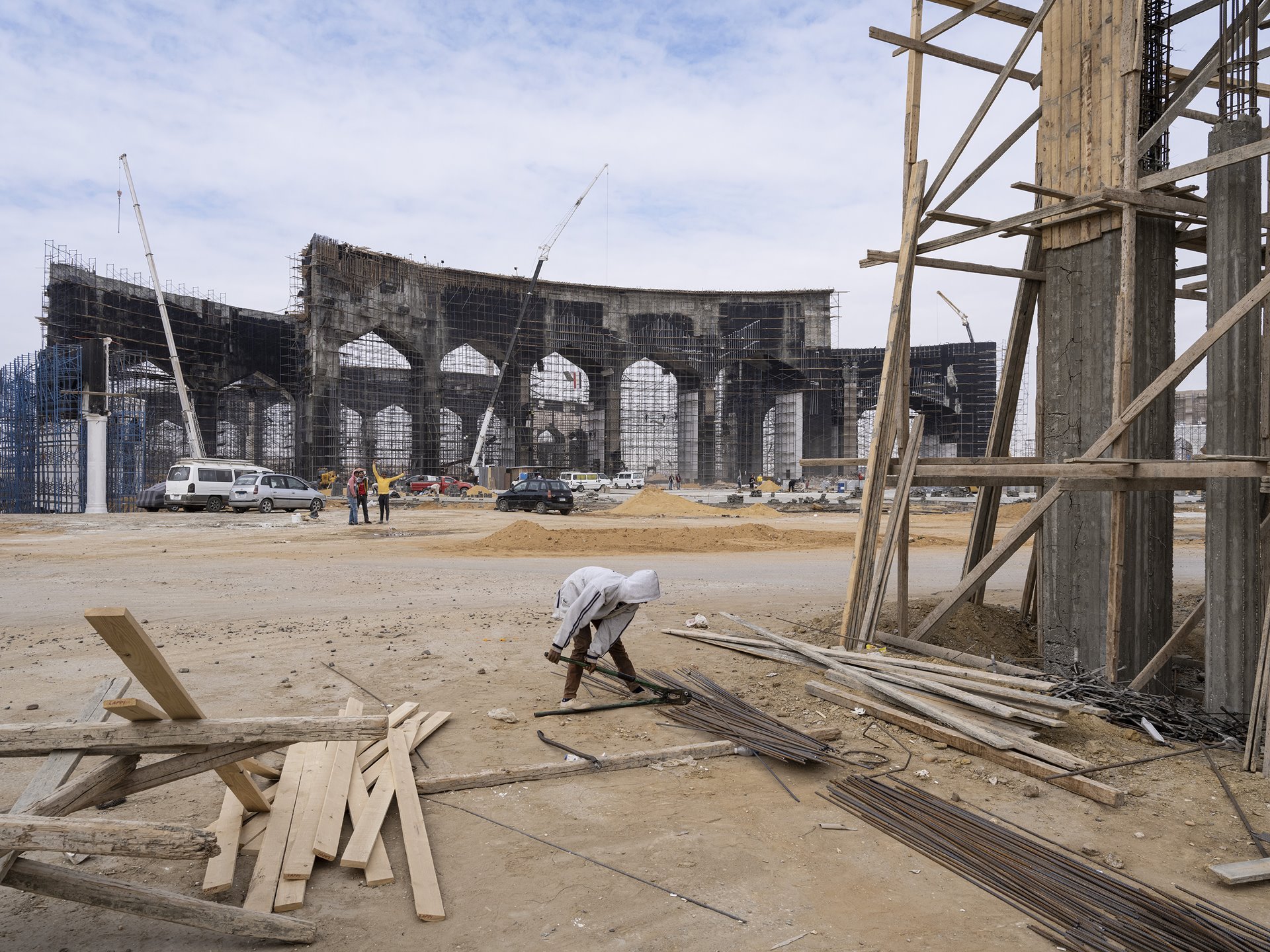 <p>Workers construct one of the giant entrance gates to Egypt&#39;s New Administrative Capital, under construction near Cairo. A Light Rail Transit from Cairo will pass through this gate.</p>
