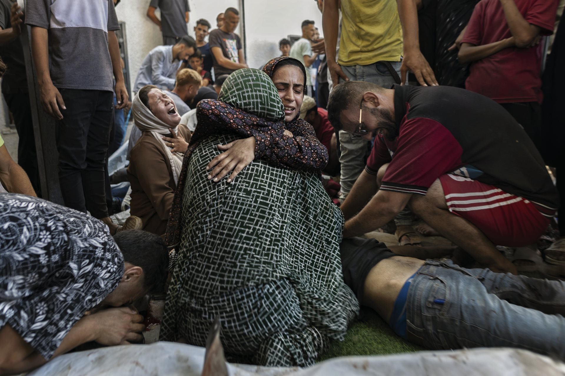People mourn at a hospital after the Israeli military attacked a beachfront cafe west of Gaza City, Gaza Strip. More than 30 people were killed, including a journalist, and more than 50 were wounded.