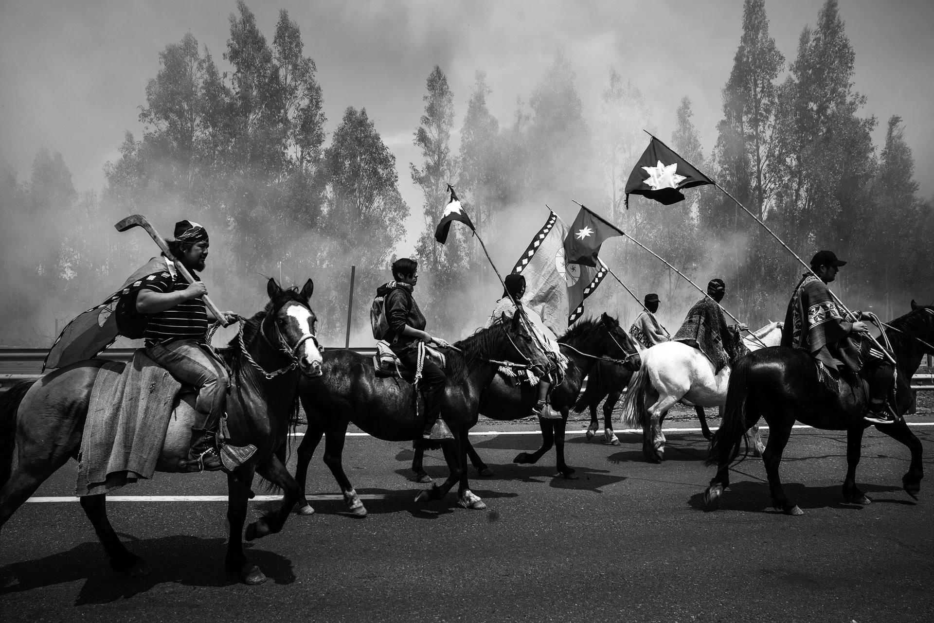 People process along Ruta 5, Chile&#39;s main highway, in Ercilla, Araucania, on the first anniversary of the killing of Camilo Catrillanca, a prominent Mapuche weichafe (community leader and defender of territorial rights), who was shot in the back of the head by members of a &ldquo;Jungle Commando&rdquo; police unit. Four police officers were arrested in connection with the incident.