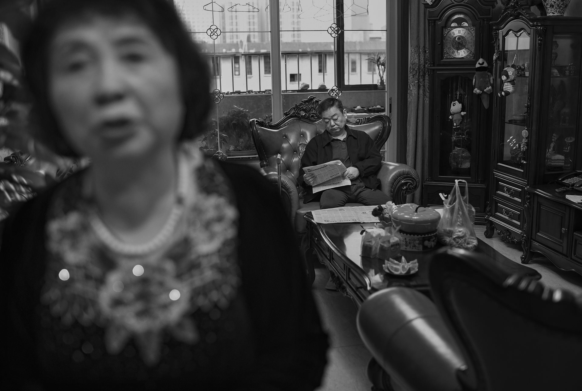 Sheng Hailin cares for her husband at home during the lockdown. Paralyzed by a stroke since 2016, Wu Jingzhou was unable to move independently, leaving Sheng Hailin to care for two children and an ailing spouse simultaneously. Hefei, Anhui Province, China.
