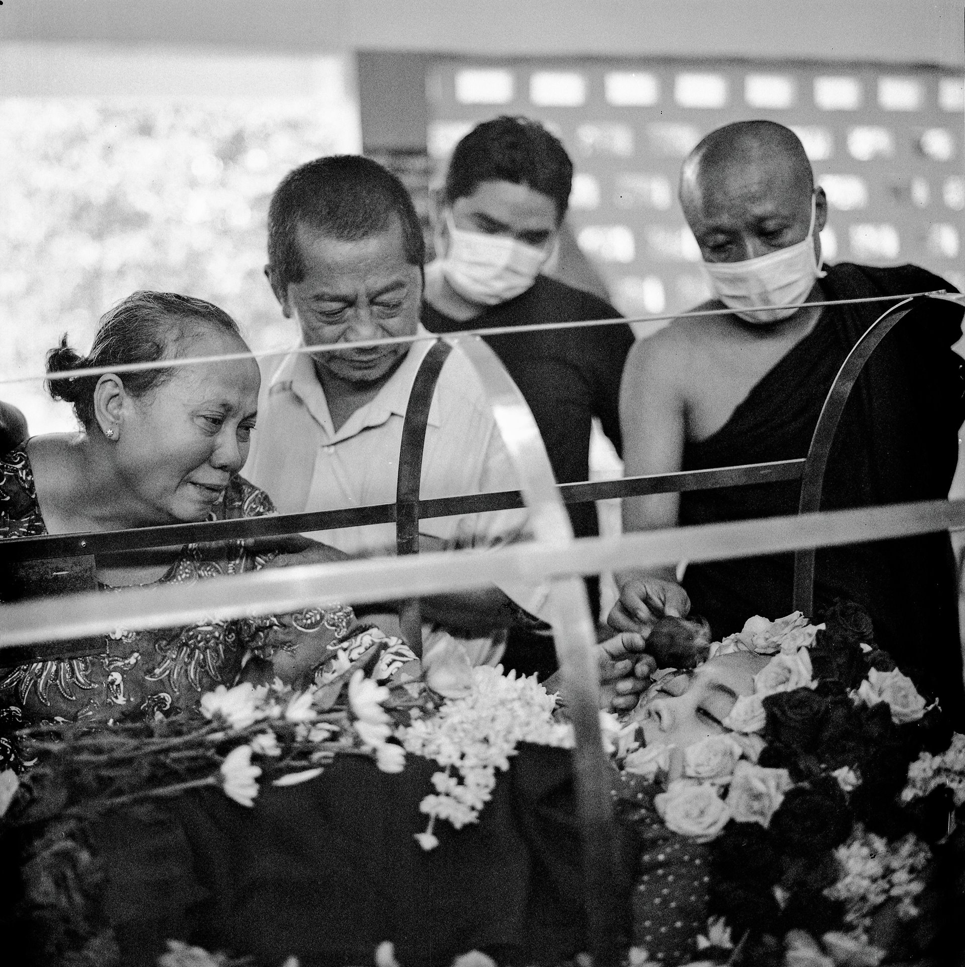 The mother of Su Su Kyi mourns during her funeral service in Yangon, Myanmar. Su Su Kyi, who was employed by a bank, was shot in the head by the military while traveling in a company vehicle on 30 March 2021.