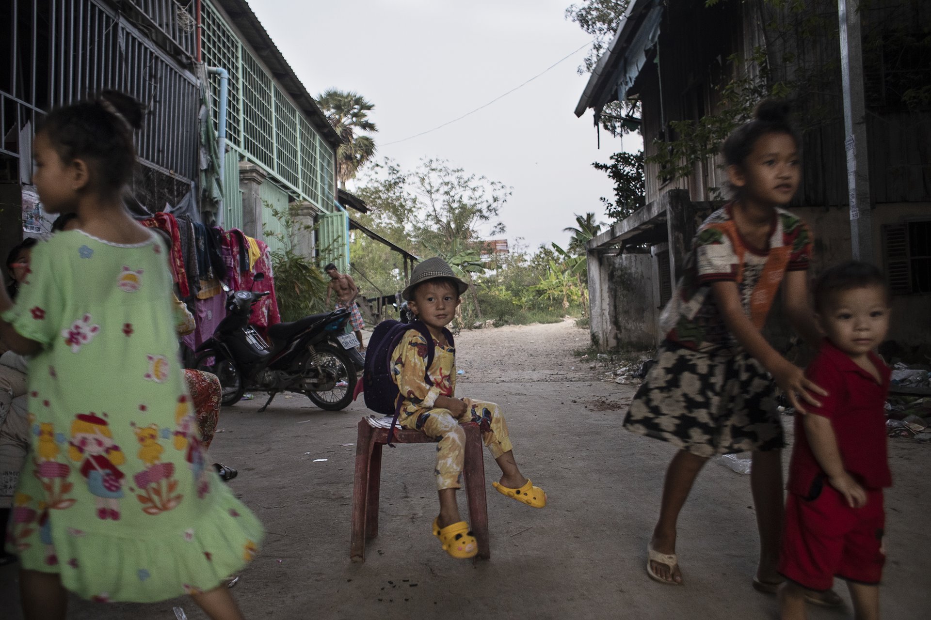 Siyeahoeung China (3) plays with neighbors and family members in his neighborhood, the red light district of Phnom Penh.&nbsp;