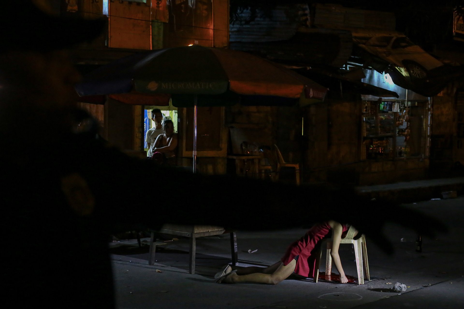 <p>The body of Kristita Padual lies at the crime scene, after unidentified murderers on motorcycles killed her and Ernesto Mortiz while they were having dinner beside the road, in Quezon City, the Philippines.</p>
