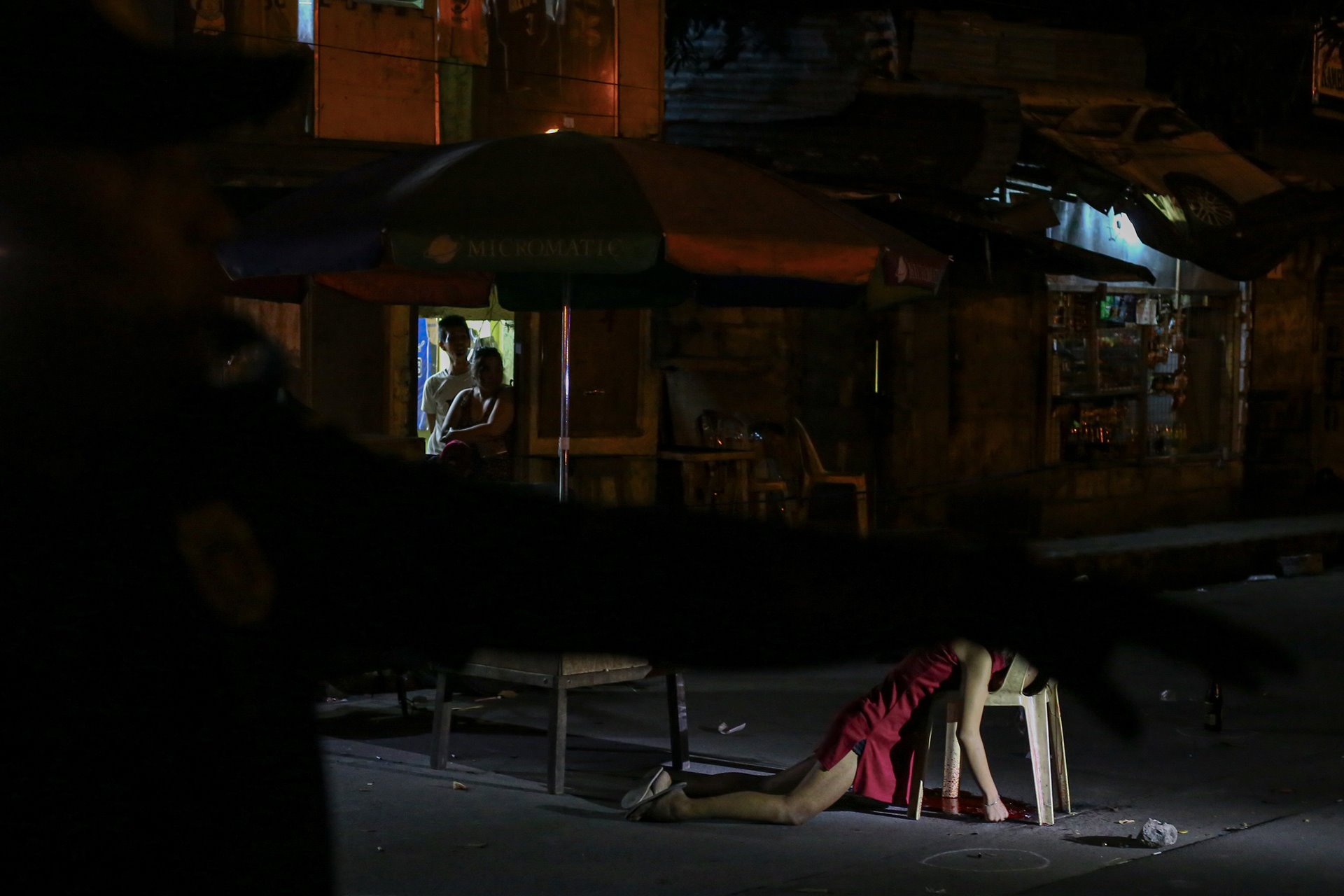 <p>The body of Kristita Padual lies at the crime scene, after unidentified murderers on motorcycles killed her and Ernesto Mortiz while they were having dinner beside the road, in Quezon City, the Philippines.</p>
