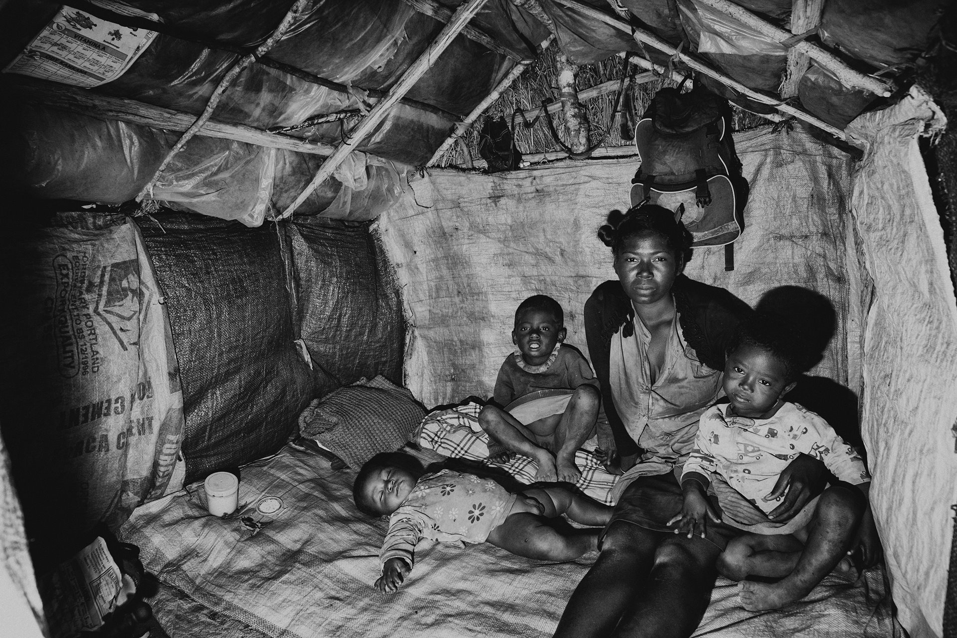 Rasoa Sylvia and her three children sit in their house in the village of Ankilidoga, in Sampona, southern Madagascar. She farms tomatoes and cassava, but has no crop this year. Southern Madagascar is gripped by a severe food crisis, following several months of drought since decades.