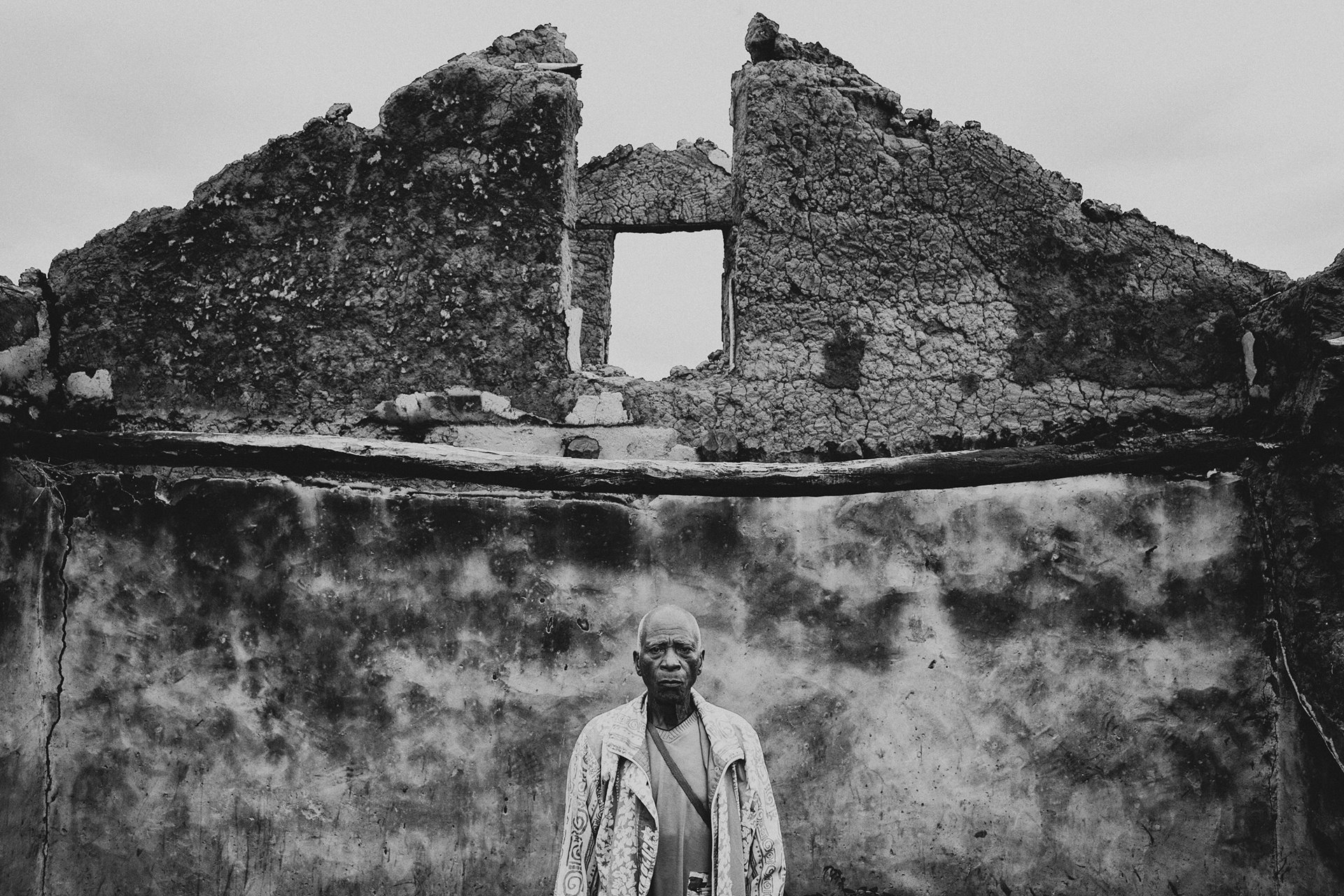 Feve stands in front of the ruins of his home in Andriry, Madagascar, which he says was burned by the military in Operation Tandroka &ndash; a government offensive against cattle thieves in the region. All the rice he had stored was lost in the fire.