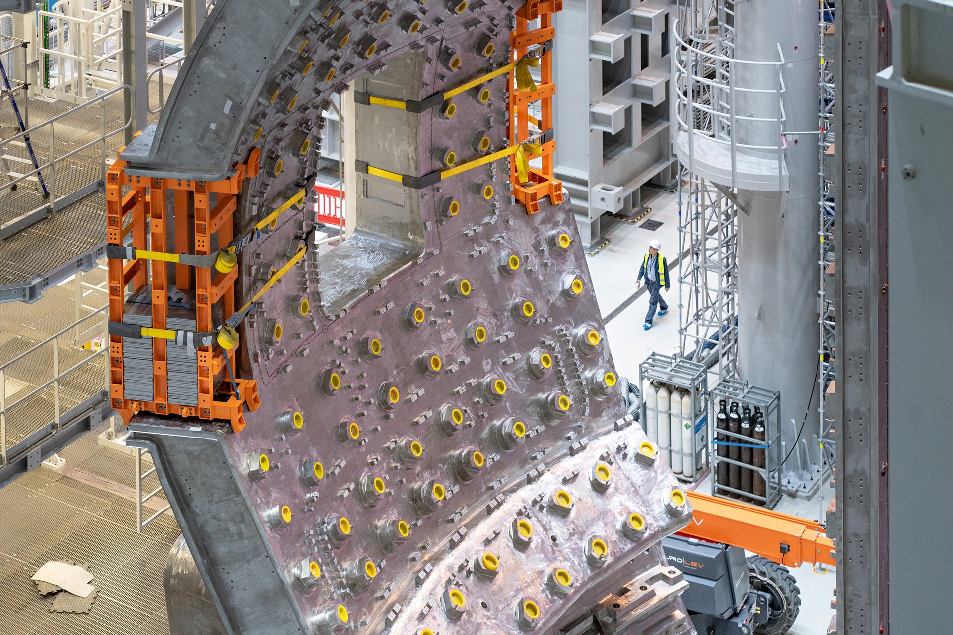 One of the nine vacuum-vessel segments that make up a tokamak nuclear fusion pit, under construction in Saint-Paul-lez-Durance, France. The tokamak is an experimental magnetic fusion device, designed to harness energy produced on the principle that powers the sun and stars. The aim of this 35-nation collaboration is that energy produced through the fusion of atoms will be absorbed as heat in the walls of the vessel, then used to produce steam and thence electricity by way of turbines and generators.&nbsp;