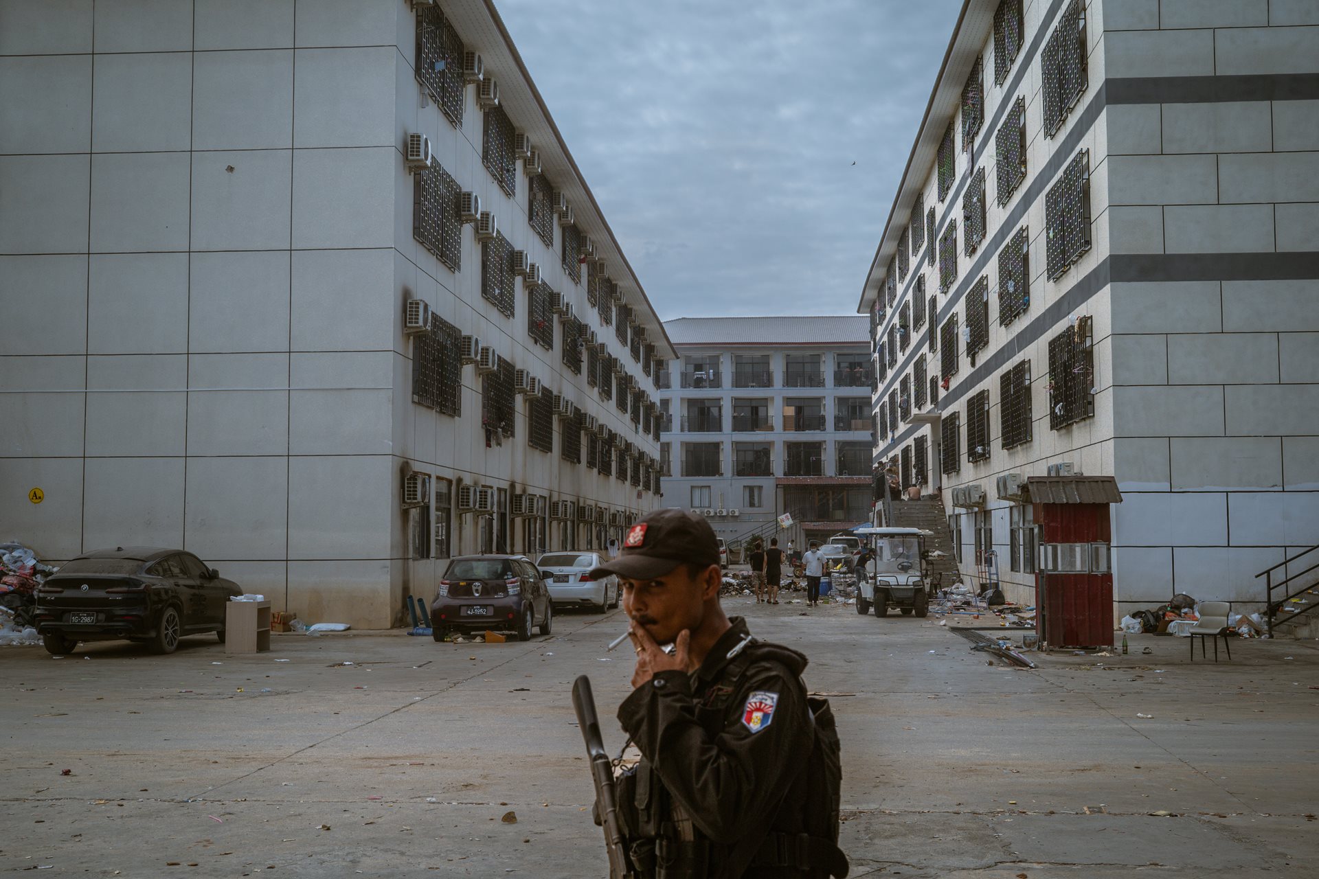A Karen National Liberation Army soldier patrols the Shunda Park compound in Min Let Pan, Myanmar. Approximately 900 Chinese employees remained barricaded here for weeks after the raid, fearing that repatriation could lead to immediate arrest by Chinese authorities.