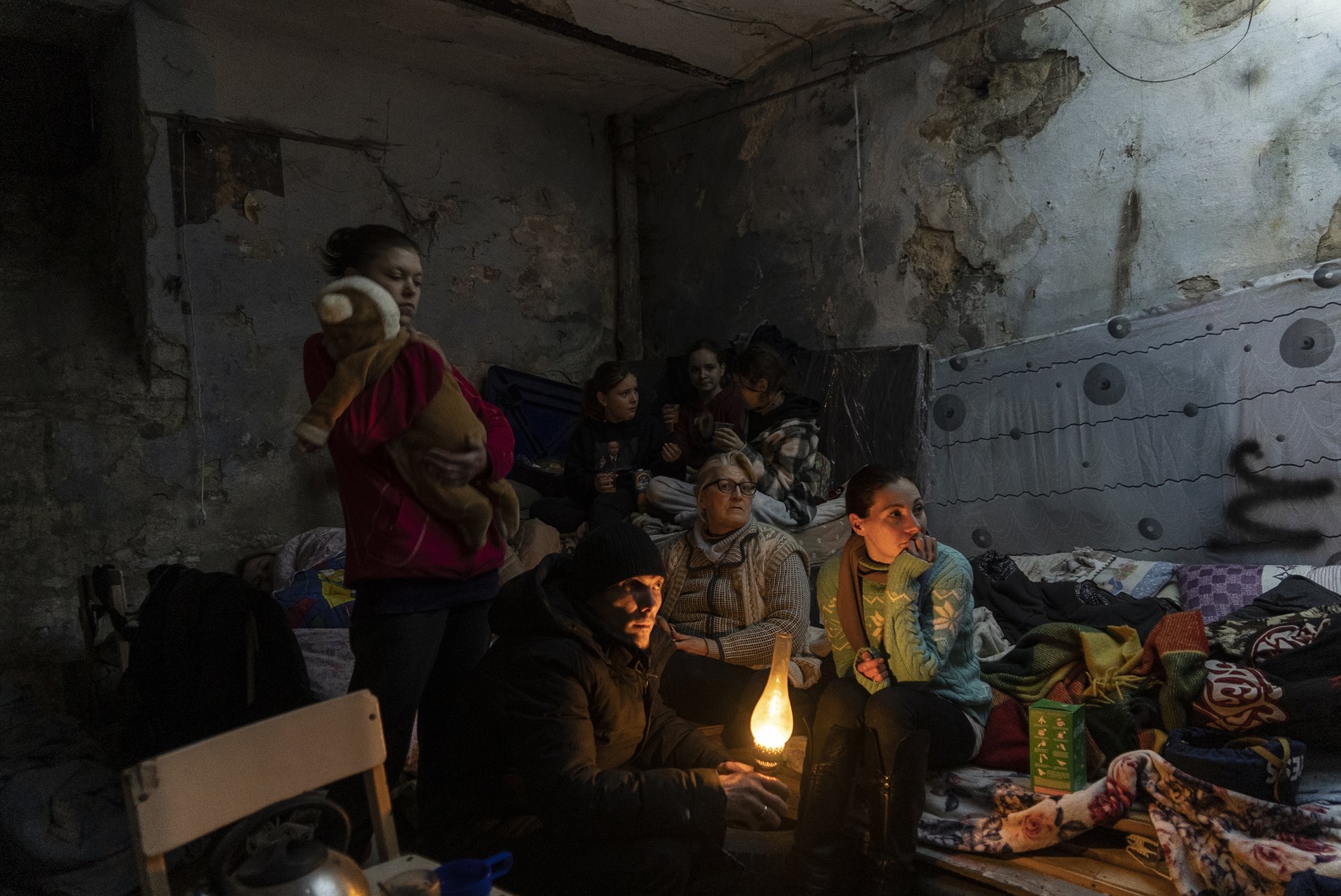 <p>Zhanna Goma (right) and her neighbors settle in a bomb shelter in Mariupol, Ukraine.</p>
