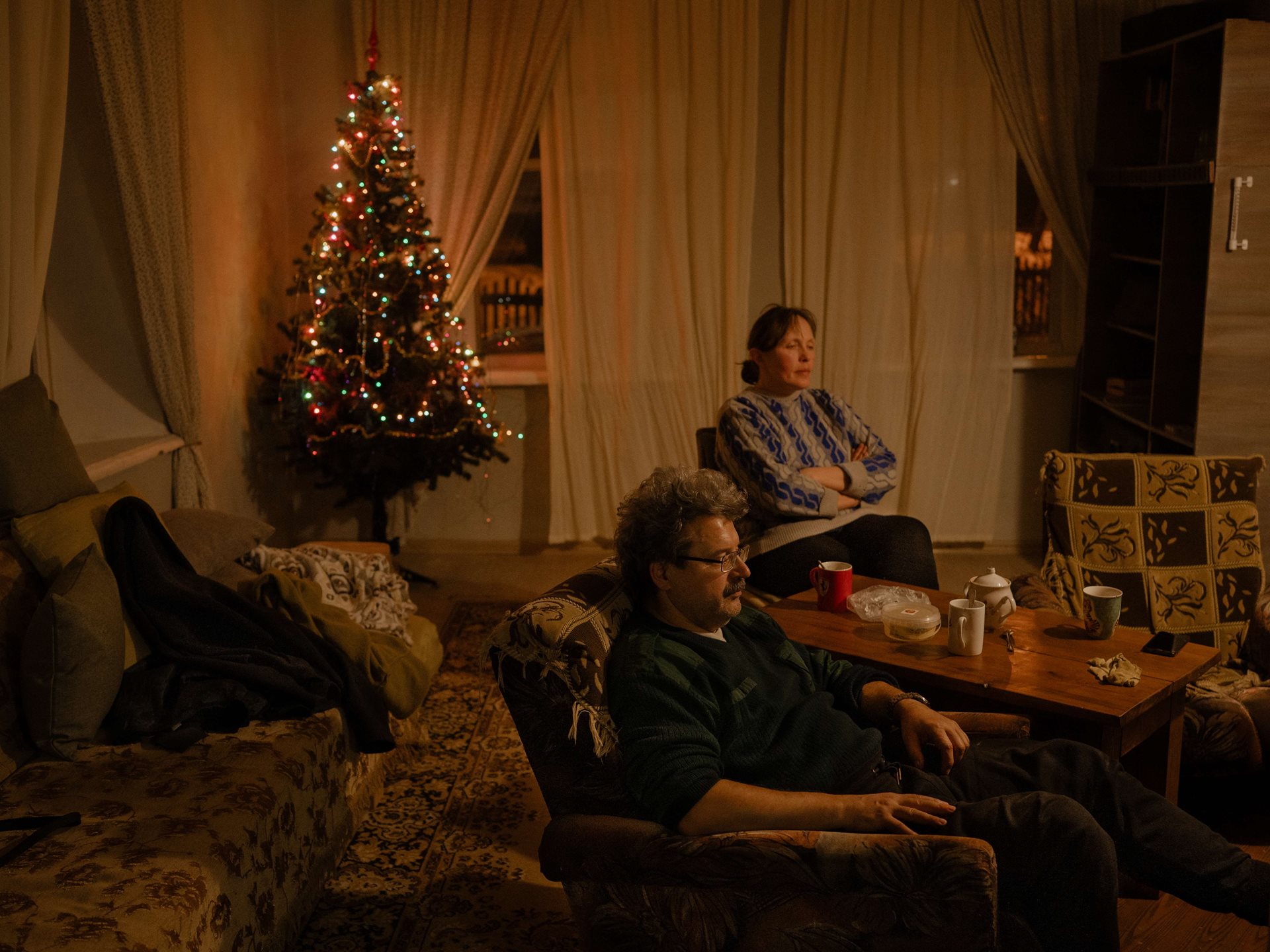 Aliona&rsquo;s parents sit in the living room at their dacha (holiday home), in Tomsk, Russia. The Christmas tree remains in the corner year-round, to give a feeling of coziness.