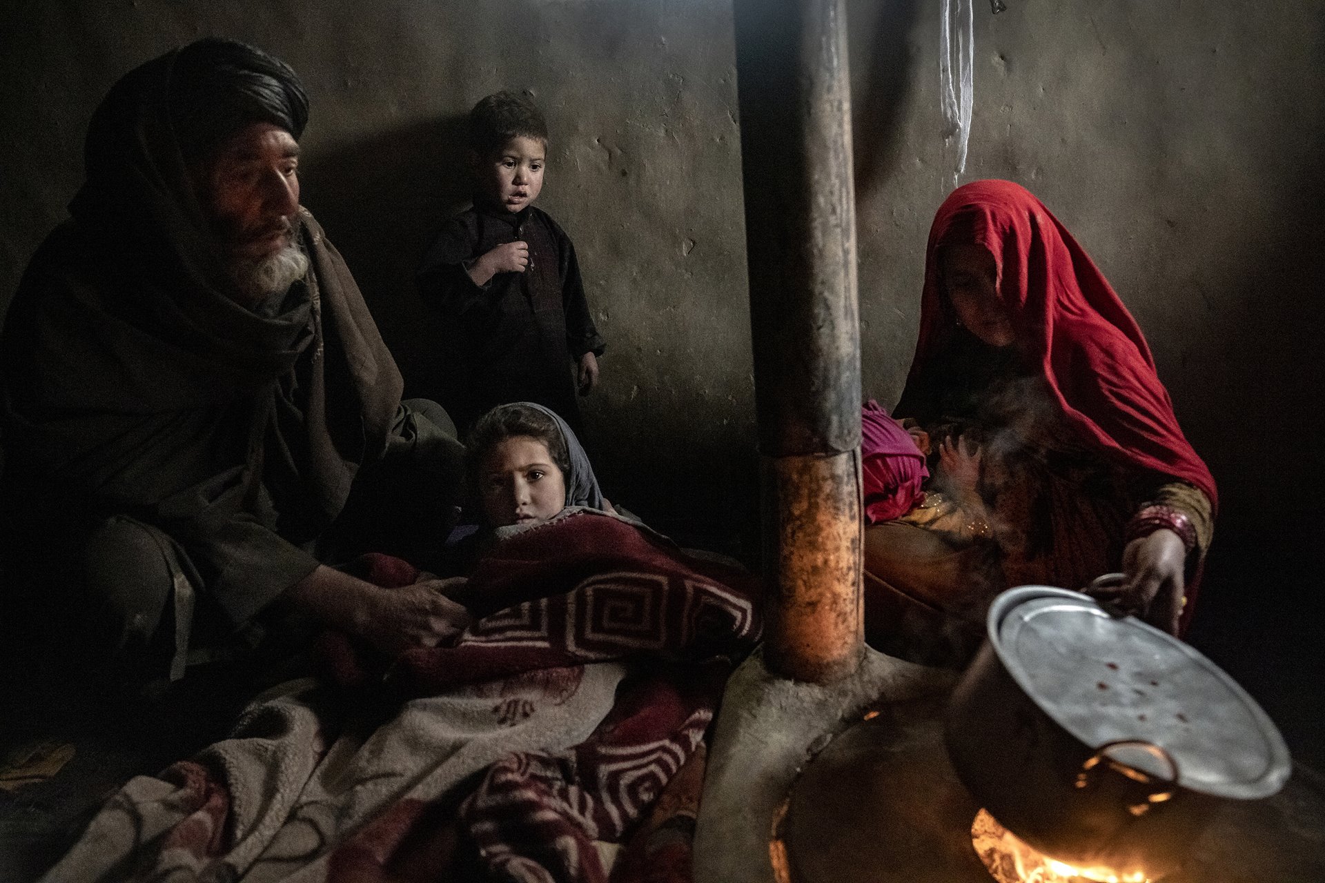 An Afghan couple care for their sick child in a camp for internally displaced people near Kabul, Afghanistan. They cannot afford medical treatment.