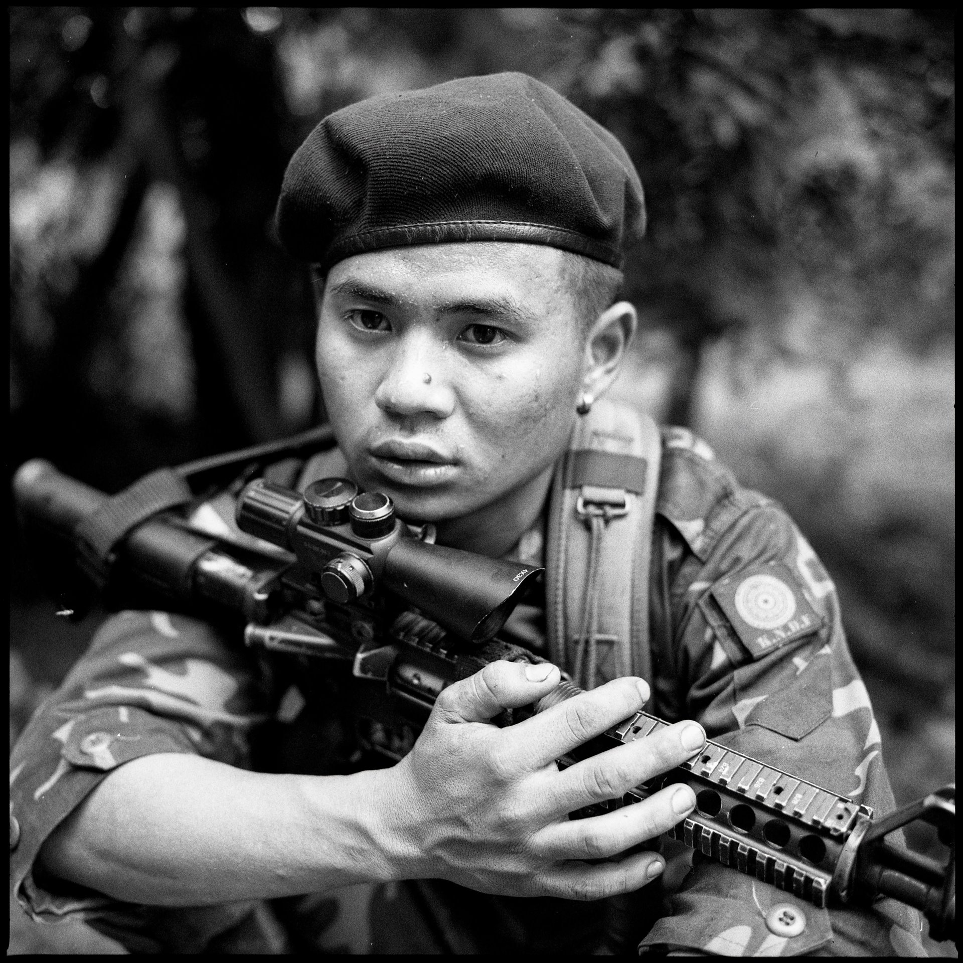 Paul Du (19) a rebel fighter with the Karenni Nationalities Defense Force (KNDF) rests under a tree on the front line, in Kayah (Karenni) State, Myanmar. He was injured by a Myanmar military artillery shell three days later.