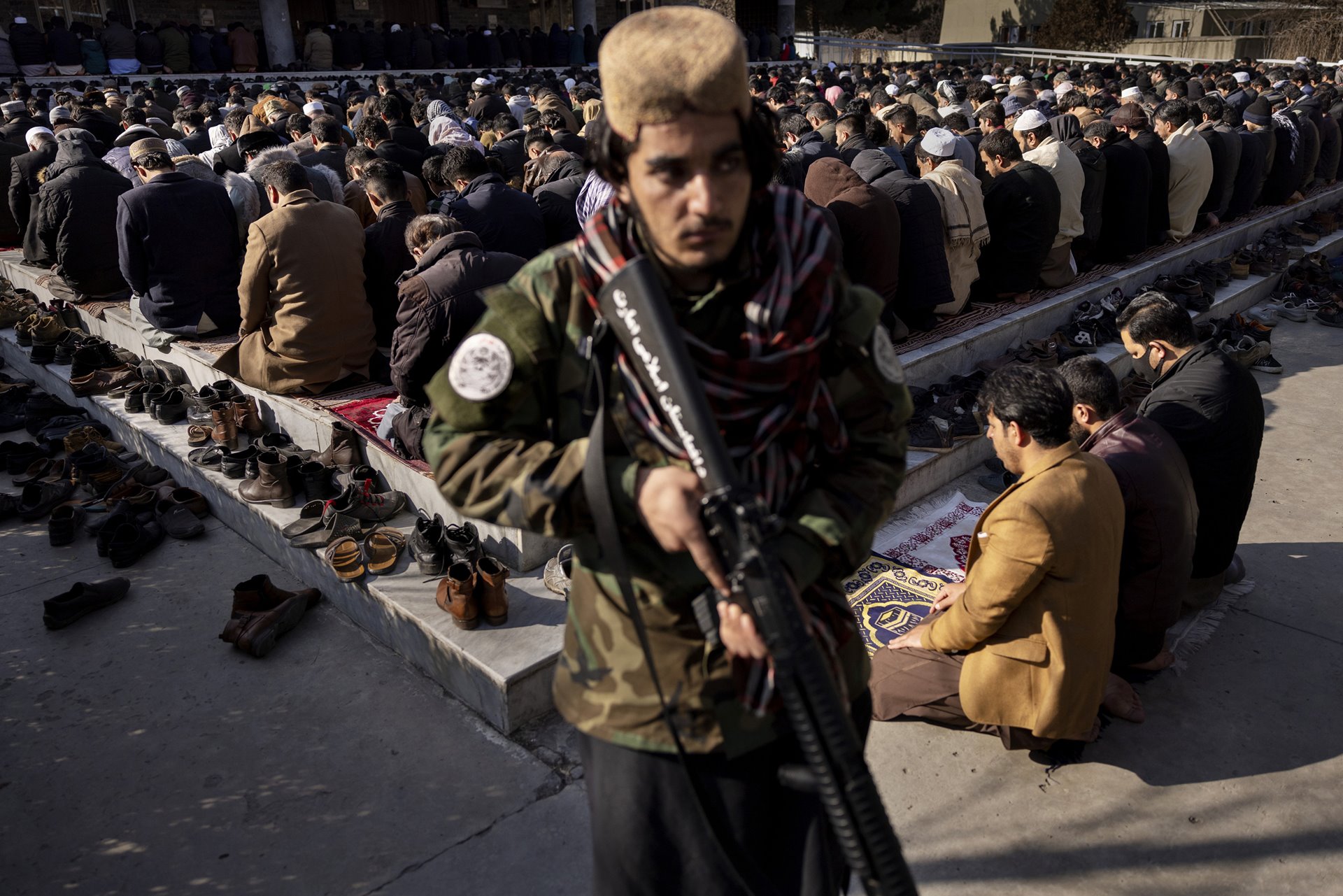 Sohalullah Hejrat (19) stands guard over Friday prayer at Sher Shah Suri Mosque in Kabul, Afghanistan. He has been with the Taliban for three years. It is common practice for boys as young as 13 to be conscripted for the Taliban.