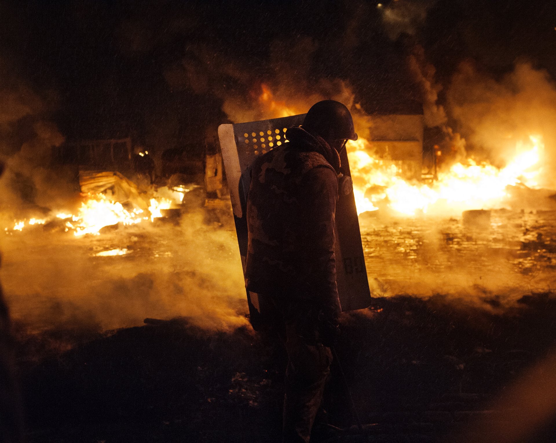 A wall of fire built by protestors as defense against armed attack by security forces burns on Hrushevskoho Street in the Ukraine capital, Kyiv. Protests broke out after pro-Russian president Viktor Yanukovych pulled out of signing an association agreement with the European Union, and were violently suppressed.