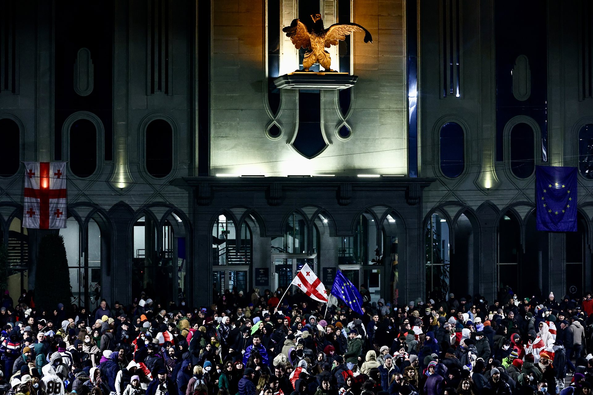 Protesters wave Georgian and European Union flags at a rally in front of the Georgian Museum of Fine Arts, opposite the parliament building in Tbilisi, Georgia.