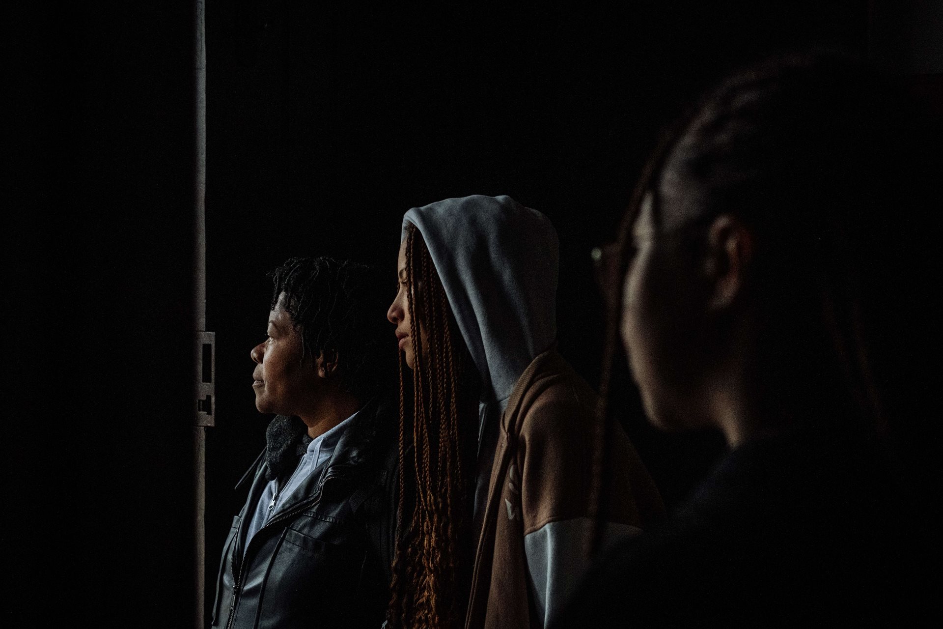 Ana Maria&rsquo;s grandchildren Leonor and Beatriz wait with her for the rain to stop, in a church doorway after mass, in Fafe, Portugal, the town where they live, 300 kilometers from Lisbon.