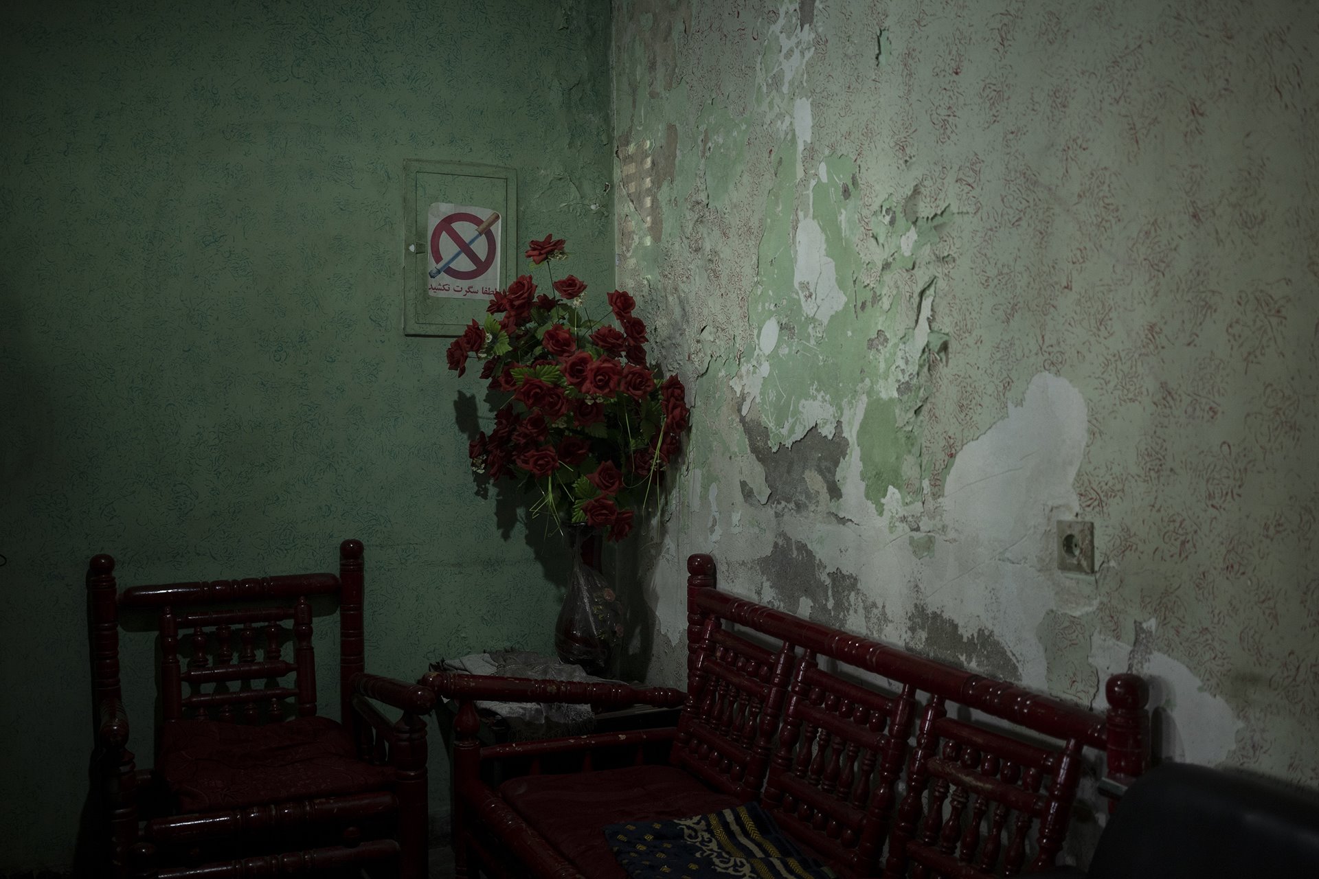 A vase of artificial roses stands inside the ticket office of the Ariana Cinema in Kabul, Afghanistan, nearly three months after the Taliban closed the cinema.&nbsp;