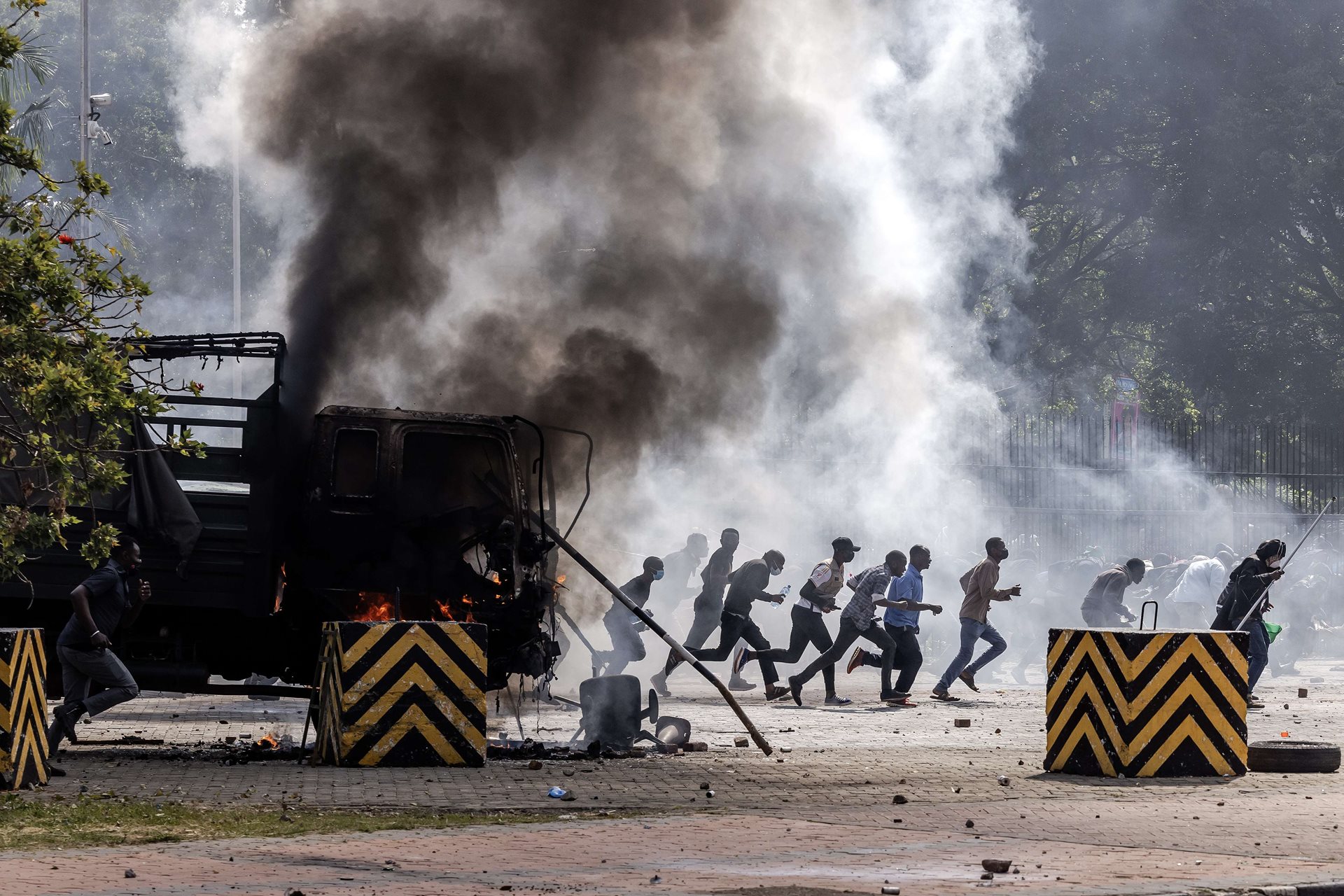Protestors take cover outside the Kenyan Parliament after storming the building in Nairobi, Kenya.