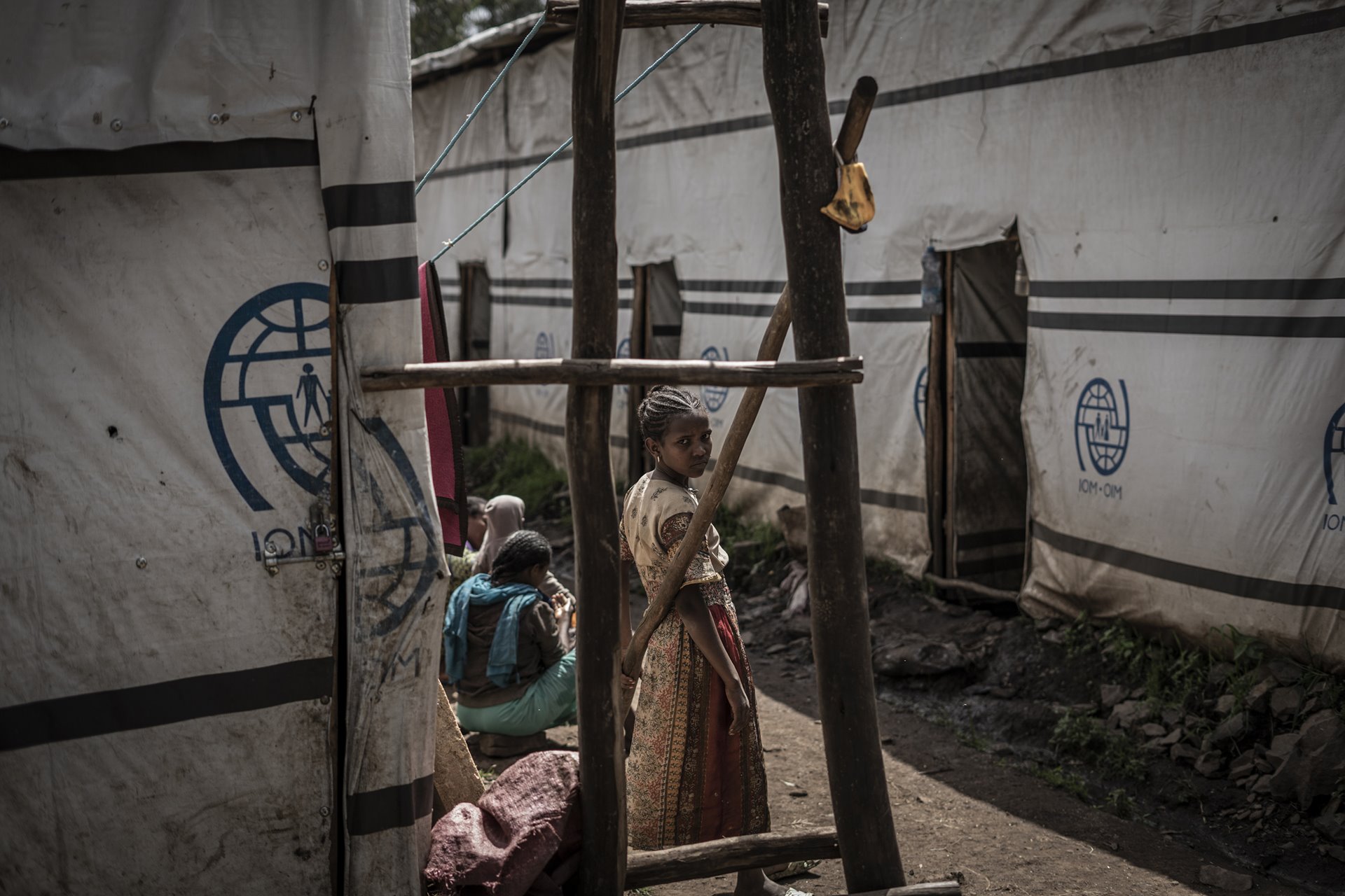 A young woman who fled fighting in May Tsemri and Shire, in Tigray, and then from Addi Arkay, in Amhara, stands in a camp for internally displaced people in Dabat, 70 kilometers northeast of the city of Gondar, Amhara, Ethiopia.