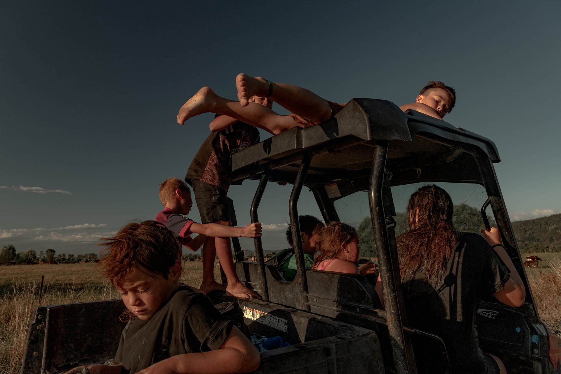Children from the Teepa family drive the younger siblings home, after a swim in the Ōhinemataroa (Whakatane) River, in Ruatoki, New Zealand. Tūhoe children are taught independence and to care for other family members.