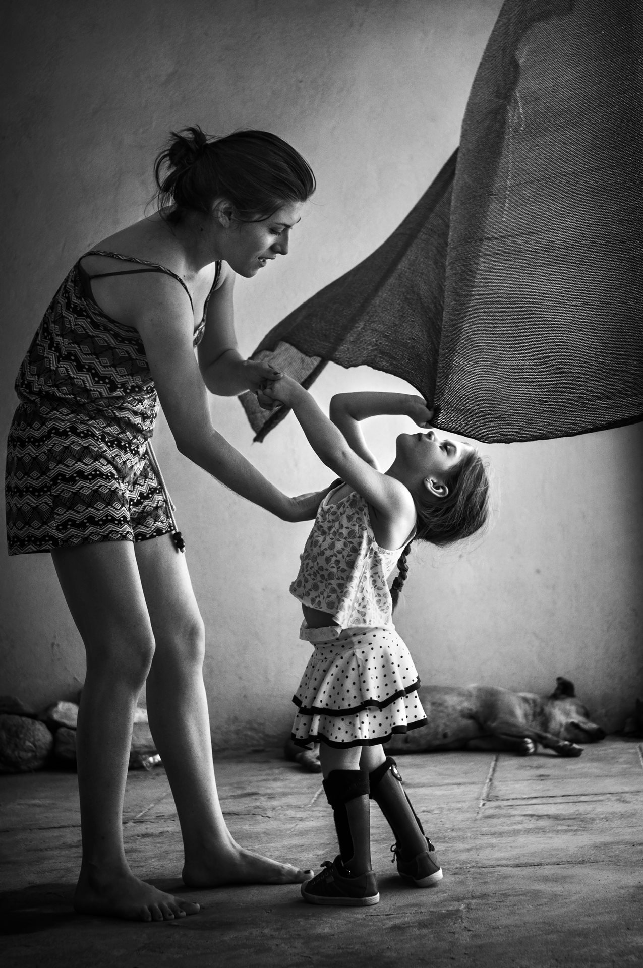 Anita Sosa, born with hydrocephalus and spina bifida, plays with her sister in Chaco, Argentina. Doctors attributed her condition to pesticides used in the soybean fields that surround her town of 3,000 inhabitants.&nbsp;