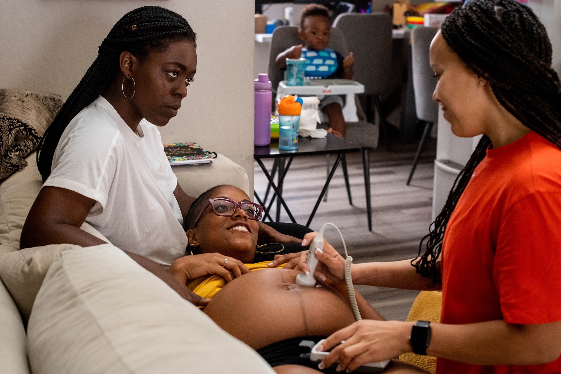 Midwife Angie Miller listens to the heartbeat of MyLin Stokes Kennedy&rsquo;s baby, with her wife Lindsay and their child Lennox at their home in Fountain Valley, California, USA.