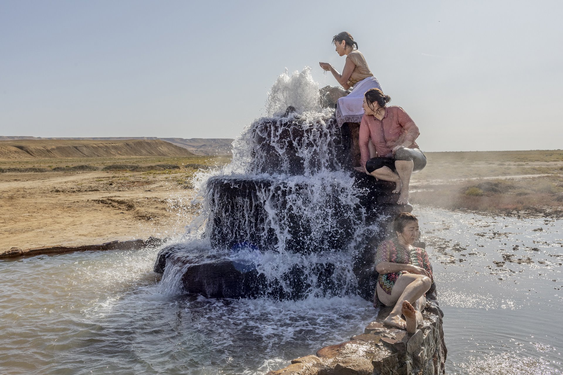 <p>Women visit a hot spring that has emerged from the dried bed of the Aral Sea, near Akespe village, Kazakhstan. Once the world&rsquo;s fourth-largest lake, the Aral Sea has lost 90 percent of its content since river water was first diverted to serve agriculture and industry in the 1960s.</p>
