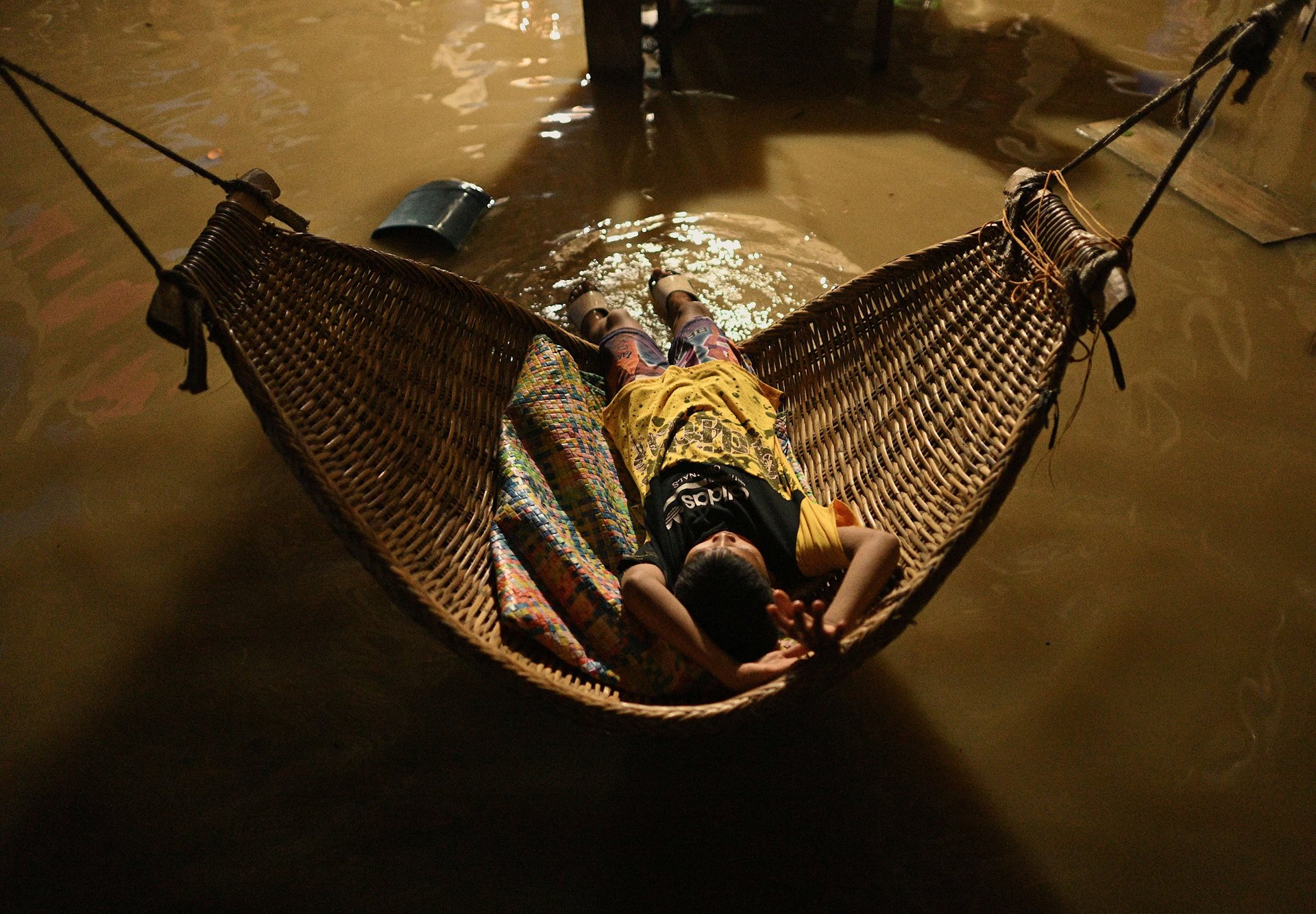 A boy tries to sleep in his flooded family home in Buguey, Cagayan, northern Philippines,&nbsp;<br />
following Typhoon Yinxing.<br />
&nbsp;
