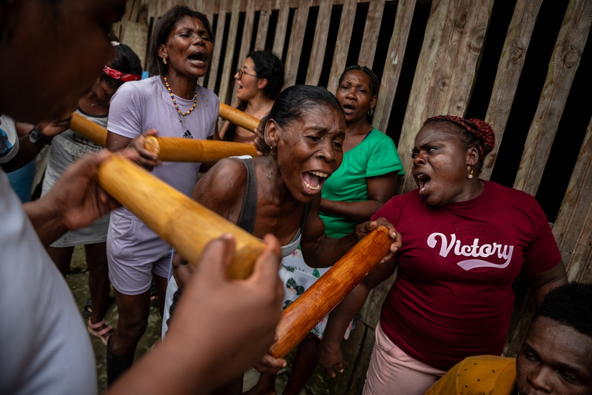 Mercedita and others sing traditional songs during a house-to-house tour in Juntas, Buenaventura, Colombia. Her singing plays an important ritual role, creating a mystical trance that &ldquo;invokes ancestral presences.&rdquo;