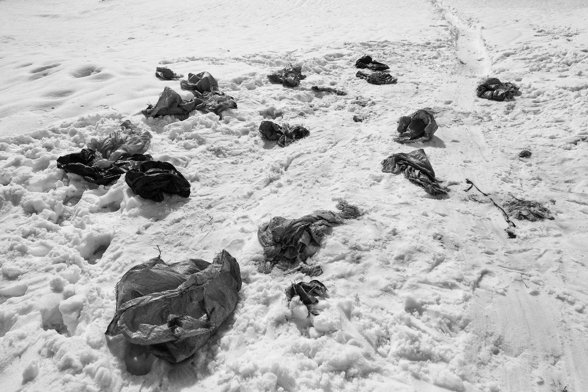 Discarded pack covers lie beside a kolbari path. Kolbars need to deliver goods in pristine condition, despite the rough terrain they carry them through. They change pack covers twice during their journey: first, when they navigate the most treacherous part of the route, and again when they are near their destination to deliver the goods.&nbsp;<br />
&nbsp;