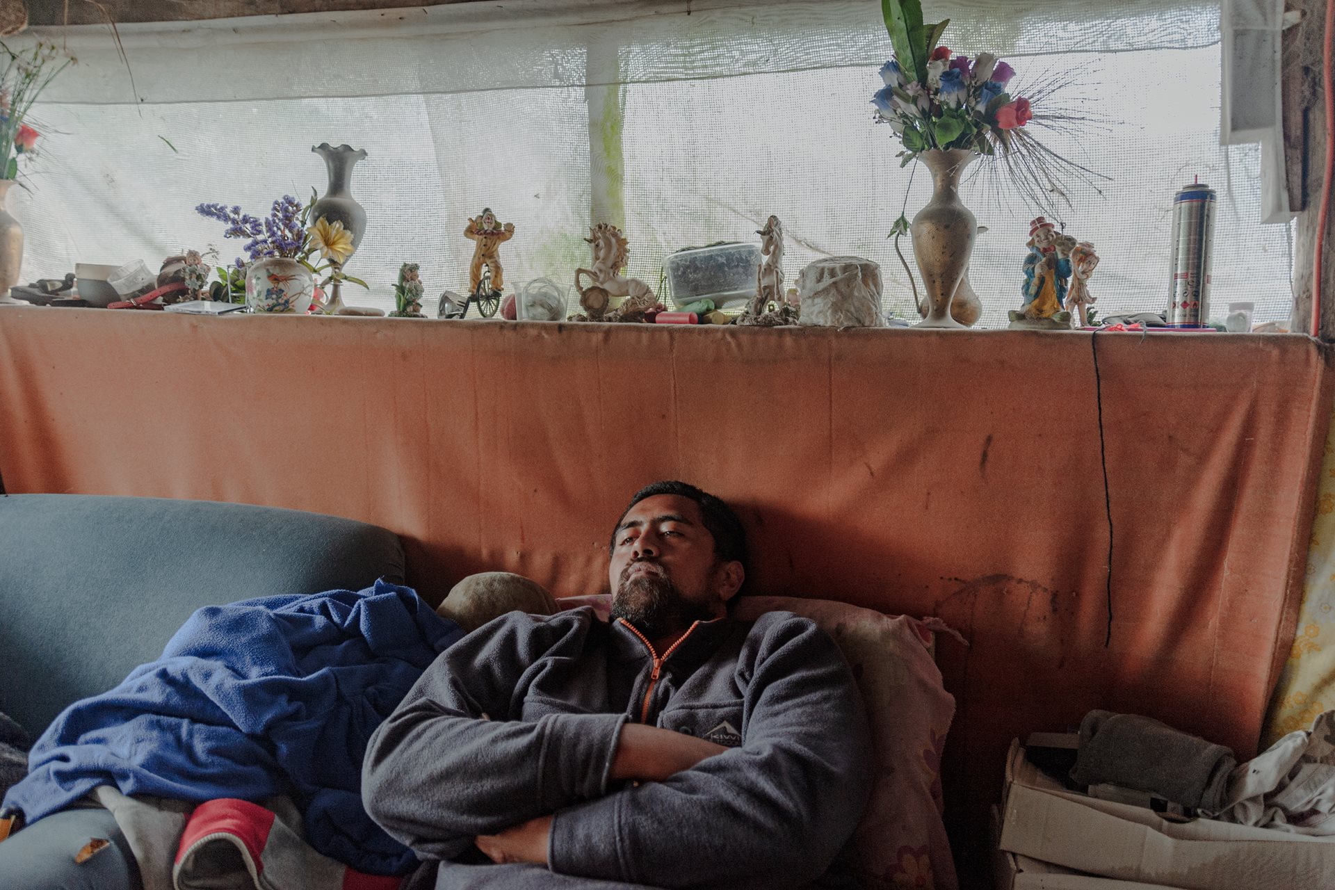 Rangikapua Teepa (23), at his parents&rsquo; home in Ruatoki, New Zealand, is both the biological grandson and whāngai (traditionally adopted) son of John and Carol Teepa. The whāngai tradition involves a child being raised by someone other than their birth parents, usually a relative. Whāngai children often maintain relationships with both birth and adoptive families. This open arrangement helps preserve cultural heritage and strengthens family ties.