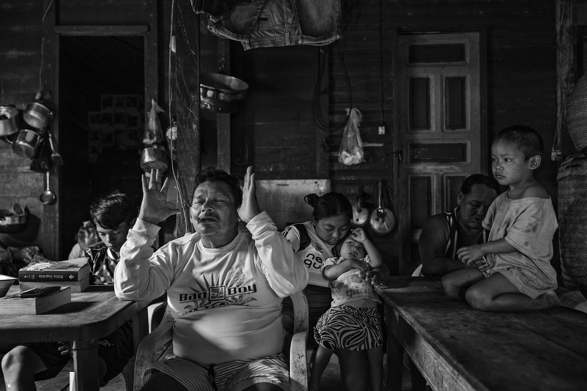 Riwu Jumi Kanamari celebrates an evangelical service with his family and friends at his home in Atalaia do Norte, in the Vale do Javari region of the Brazilian Amazon. Increasing evangelism in the region has had a strong impact on the way of life and culture of the traditional populations. Indigenous people&rsquo;s organizations raise concerns that these attempts to proselytize in their communities violate their constitutional right to maintain their cultural heritage and sacred practices, and threaten their safety. Missionary groups have been accused of spreading diseases among previously uncontacted groups, and of provoking social conflict by telling communities that their dances and beliefs are evil.