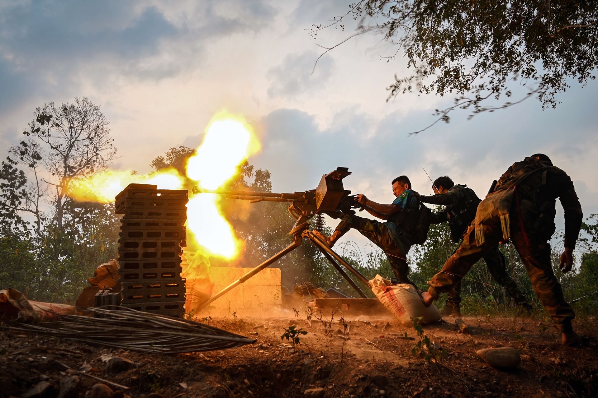 Karen National Liberation Army and PDF Special Operations Force fighters fire a heavy machine gun, in an attack on a junta military camp in Taungsoon, Kayin State, Myanmar.&nbsp;