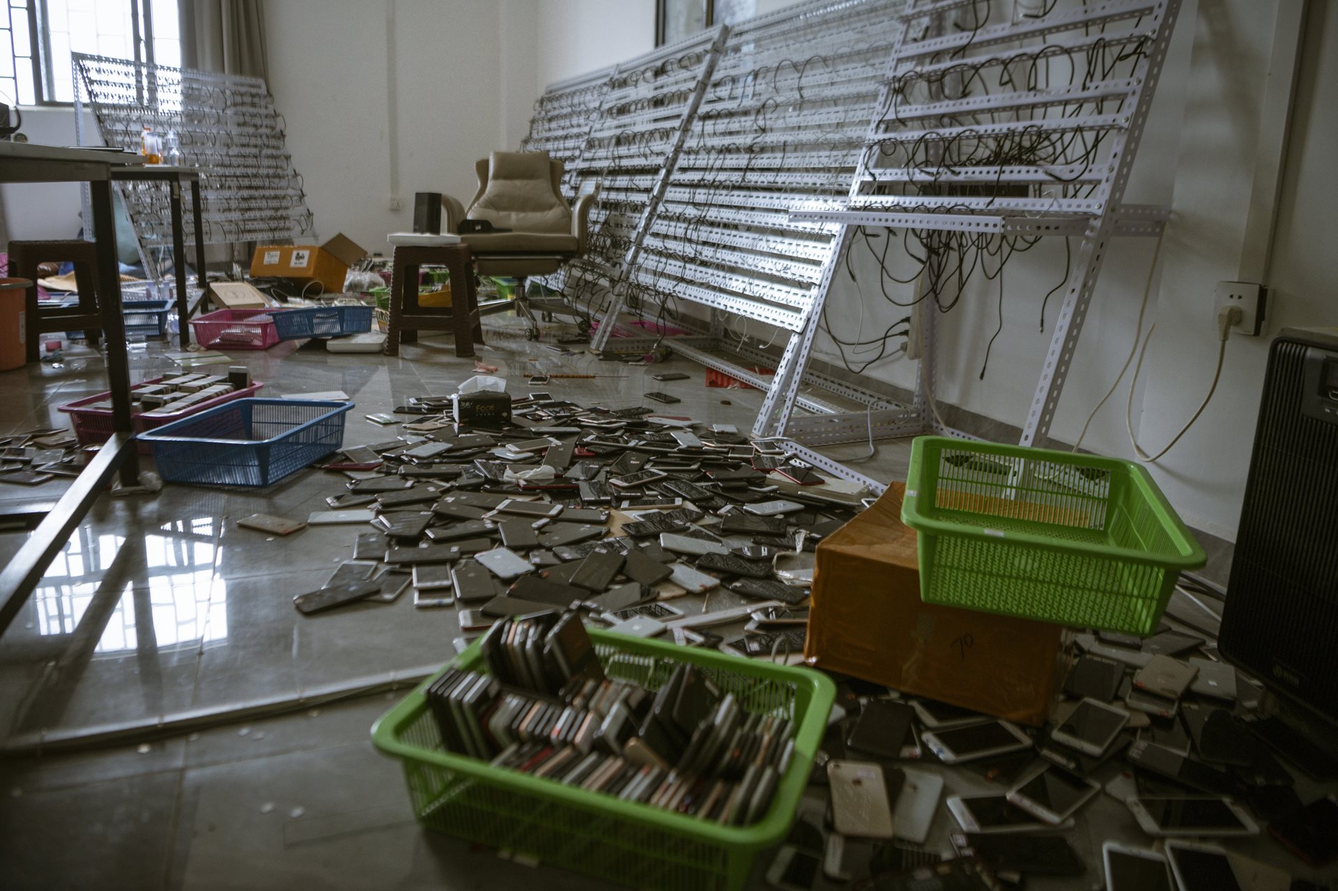 Discarded cellphones litter the Shunda Park in Min Let Pan, Myanmar complex after its capture. The scammers used generative intelligence, deepfake videos, fraudulent businesses, websites, and financial apps to reel in victims from around the world.